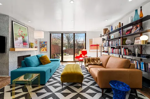 a living room with furniture and a book shelf