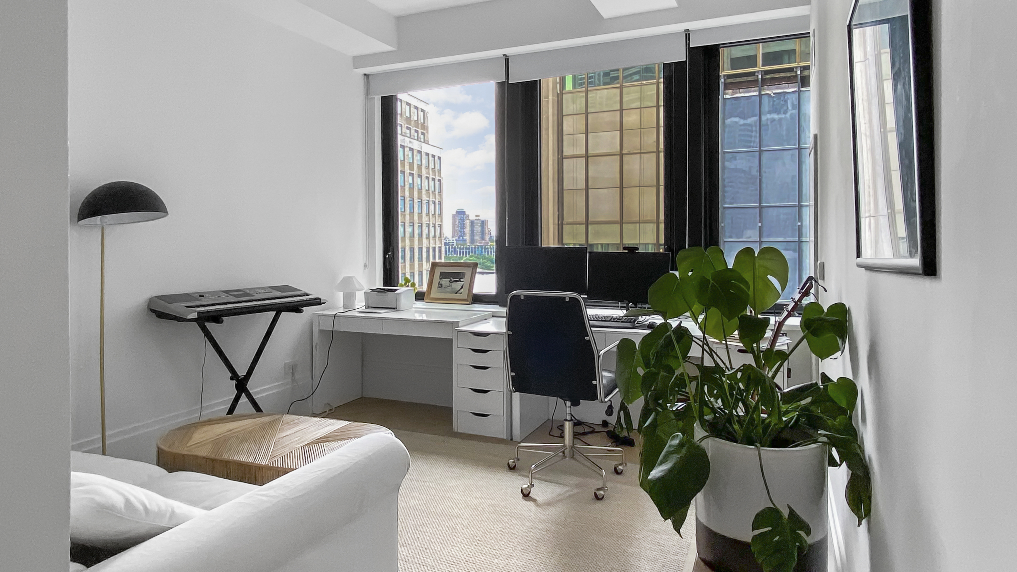 101 Wall Street, Unit 12C Manhattan, NY 10005 - Photo 4 of 18 a living room with furniture and a potted plant