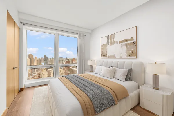 a bedroom with a large bed and a large window