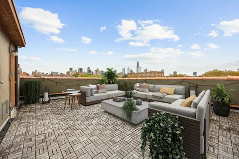 a terrace with outdoor seating and city view