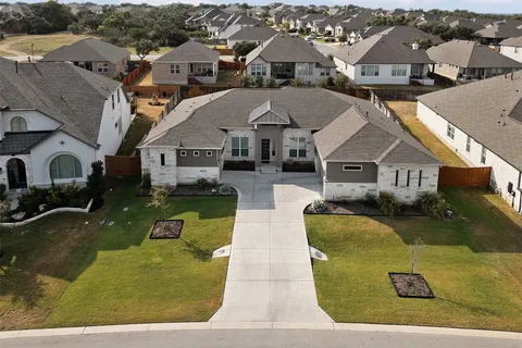 an aerial view of a house with outdoor space and swimming pool