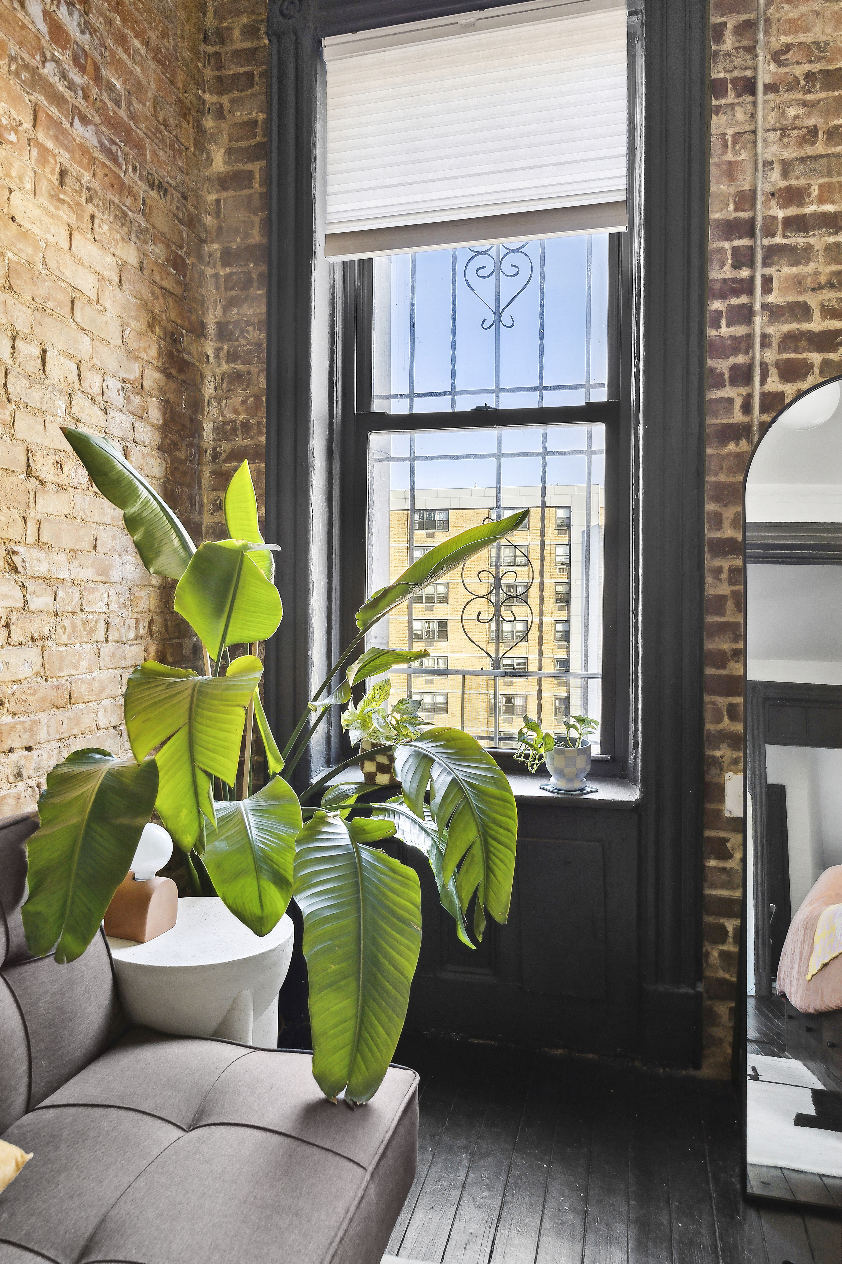 633 East 11th Street, Unit 23 Manhattan, NY 10009 - Photo 7 of 8 a living room with furniture and a window