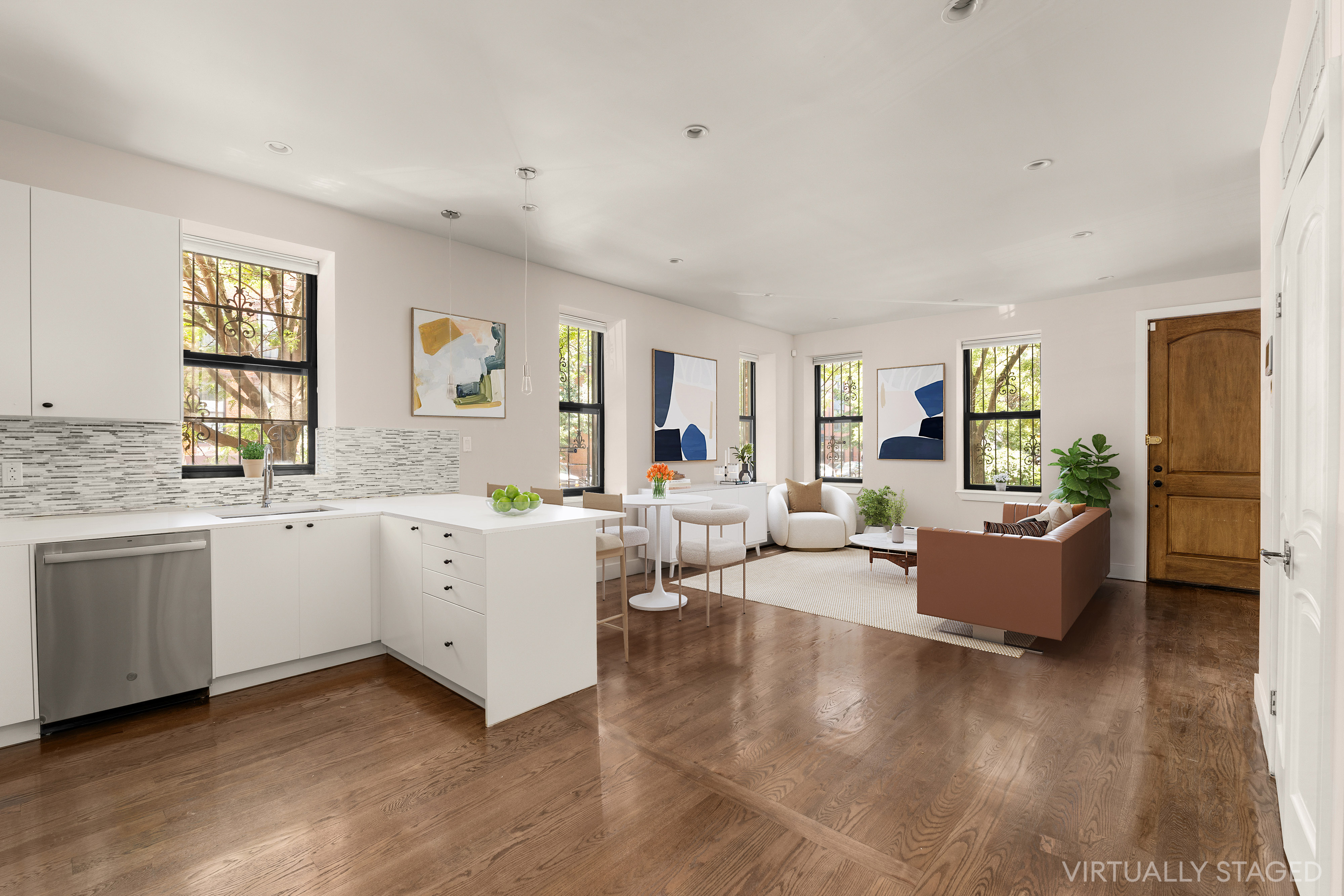 a living room with furniture and wooden floor