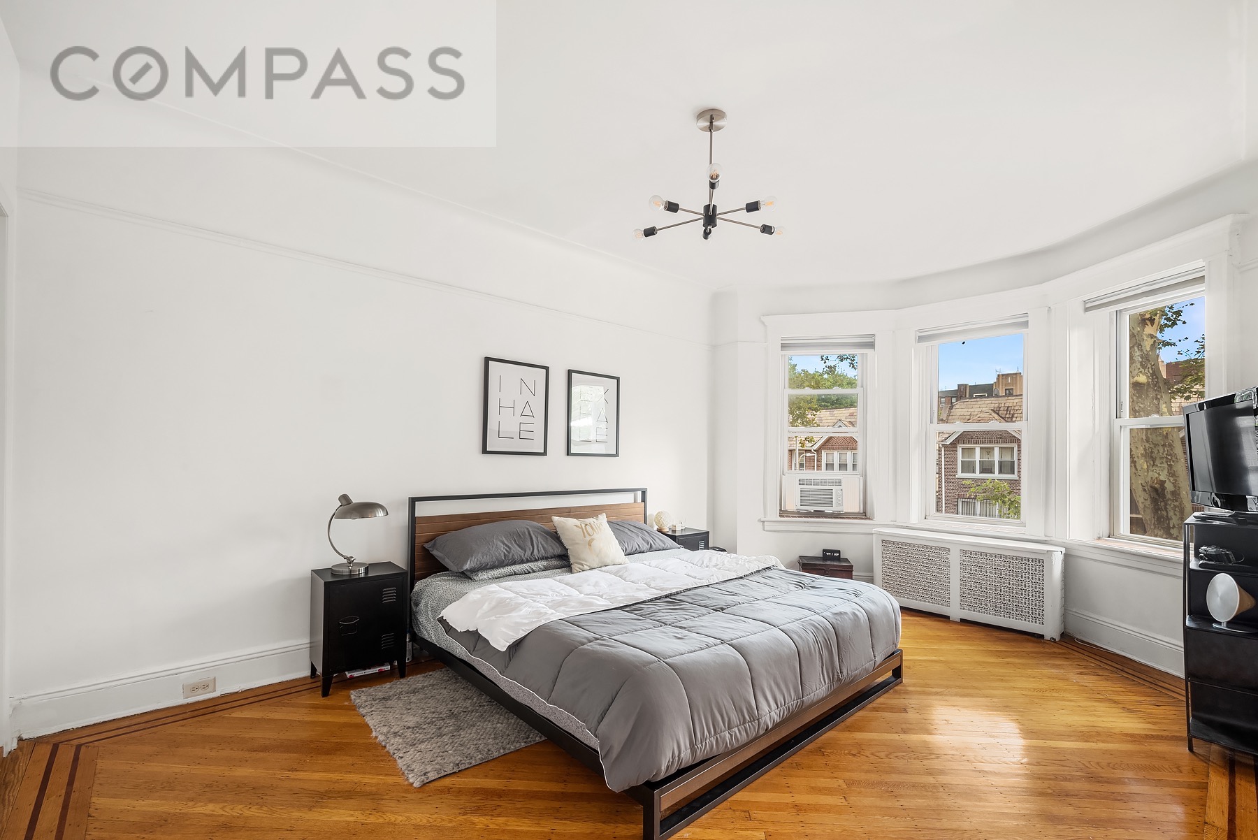 69 Sterling Street Brooklyn, NY 11225 - Photo 4 of 14 a bedroom with a large bed and a window