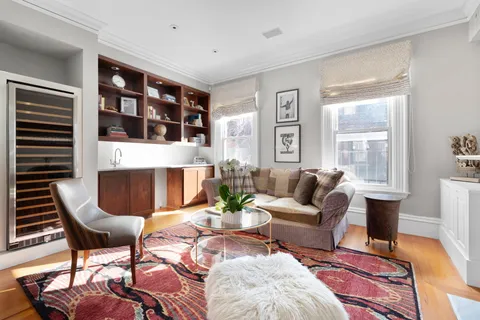 a living room with furniture a fireplace and a table