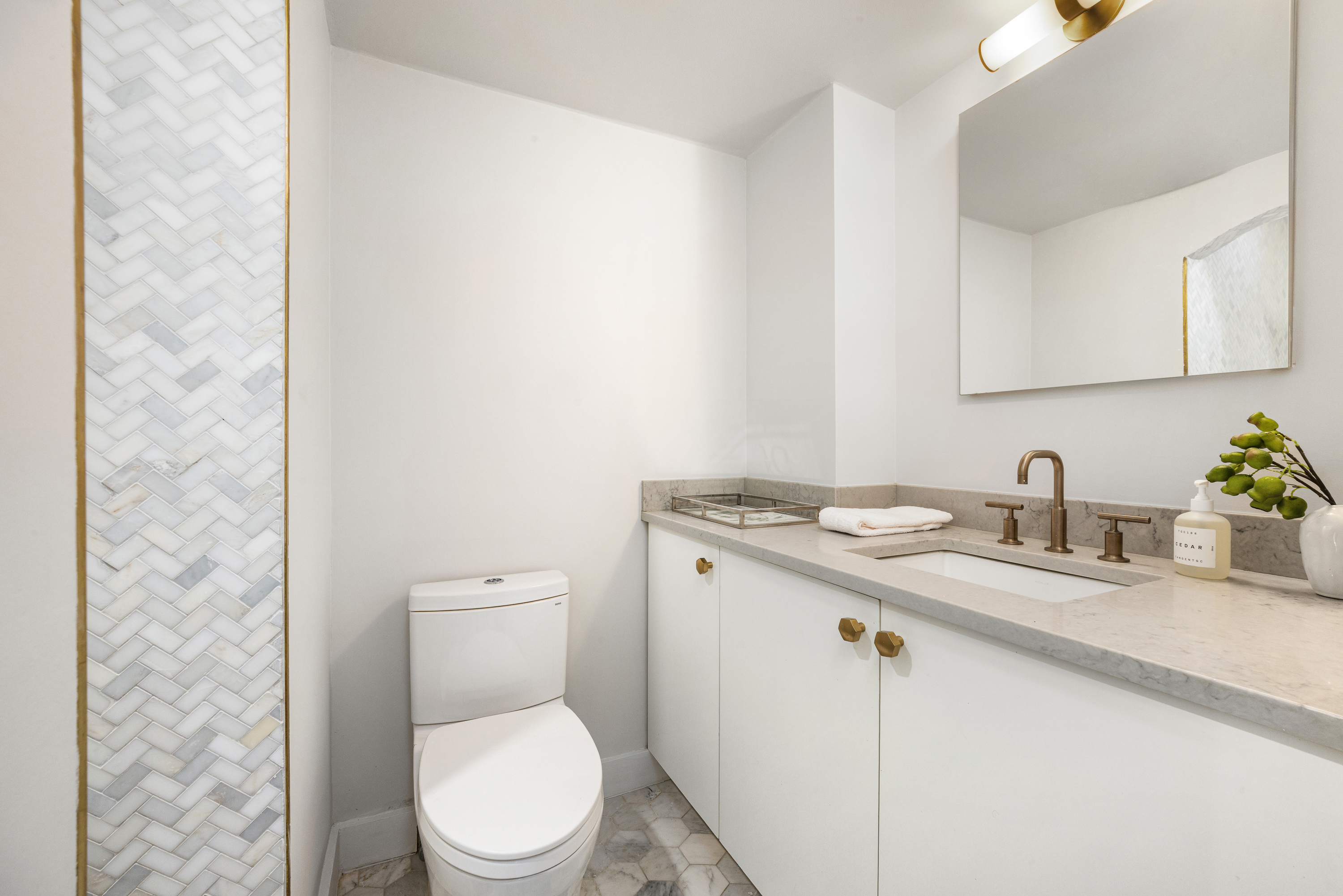 160 West 11th Street, Unit PH Manhattan, NY 10011 - Photo 13 of 16 a bathroom with a granite countertop toilet sink and mirror