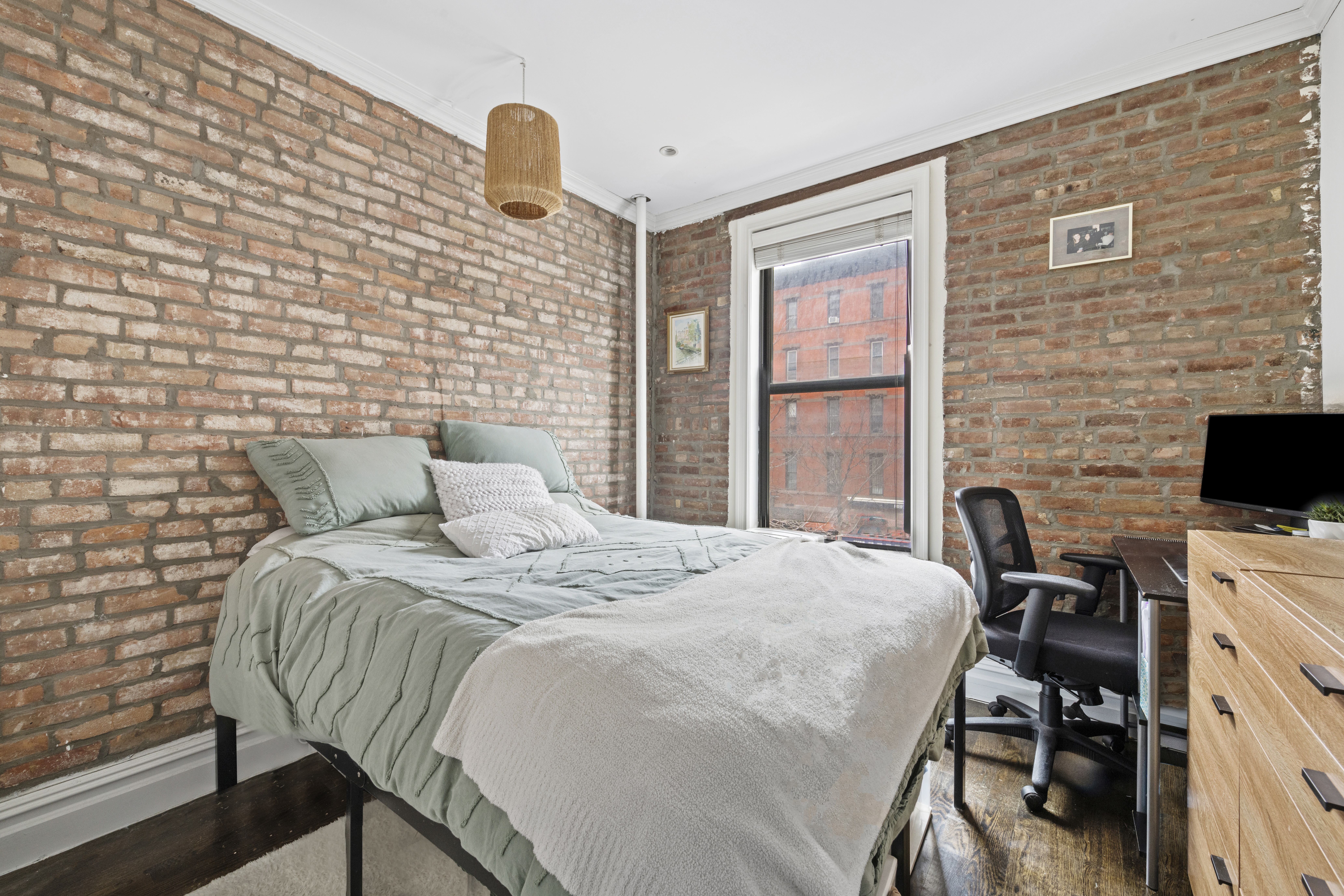 170 West 83rd Street, Unit 2W Manhattan, NY 10024 - Photo 6 of 10 a bed sitting in a bedroom next to a window with pc on the wall