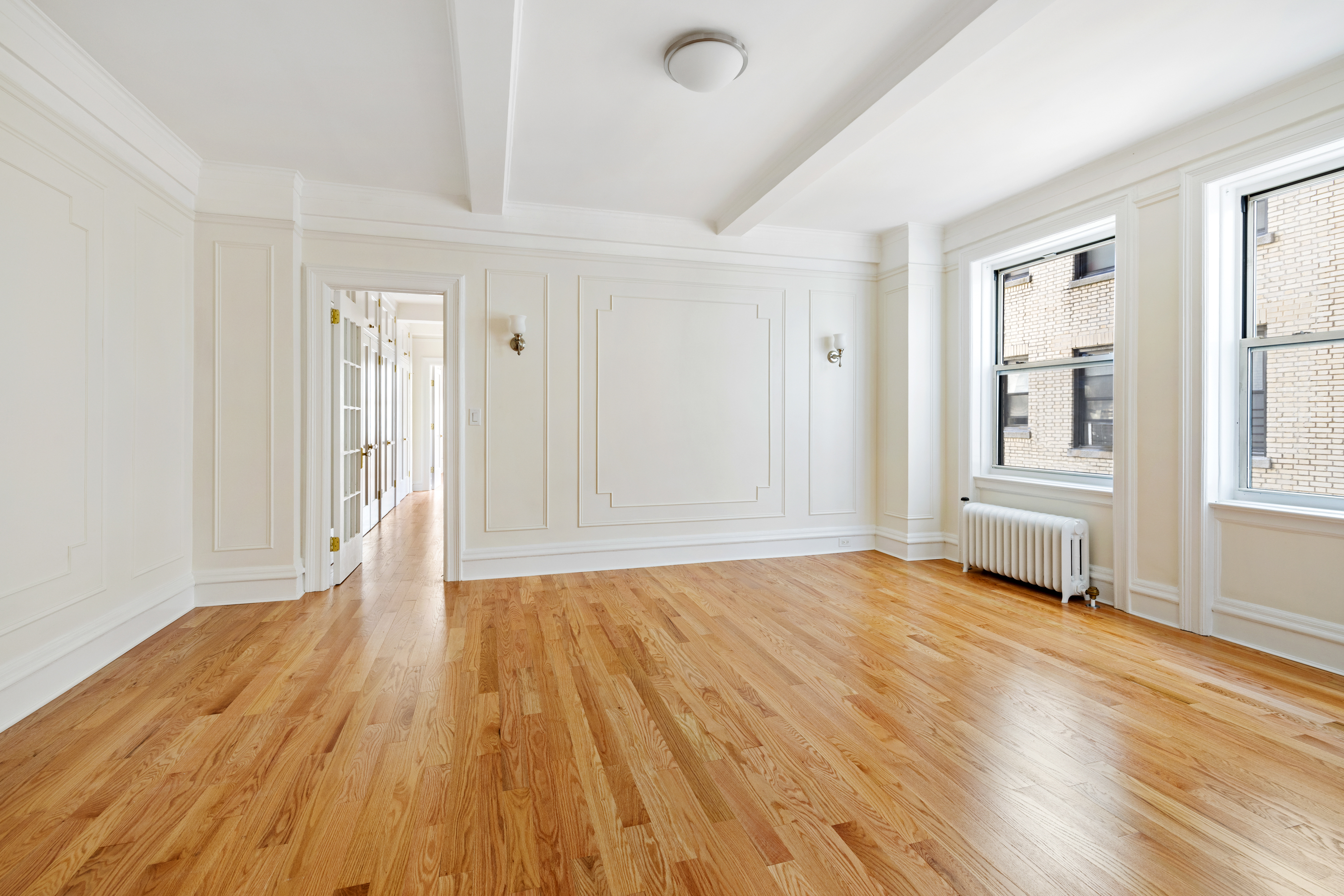 240 West 98th Street, Unit 7D Manhattan, NY 10025 - Photo 9 of 14 a view of an empty room with wooden floor and windows