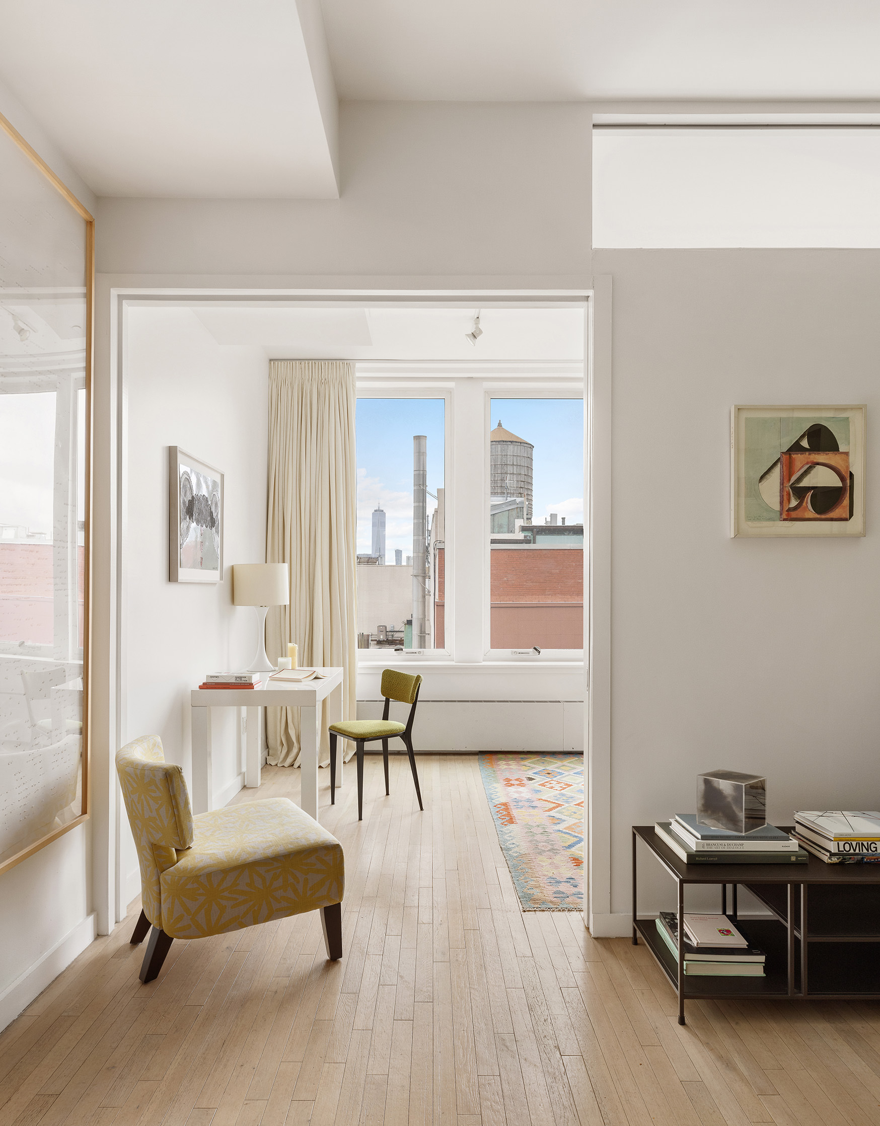121 West 19th Street, Unit 10C Manhattan, NY 10011 - Photo 4 of 14 a living room with furniture a wooden floor and a large window