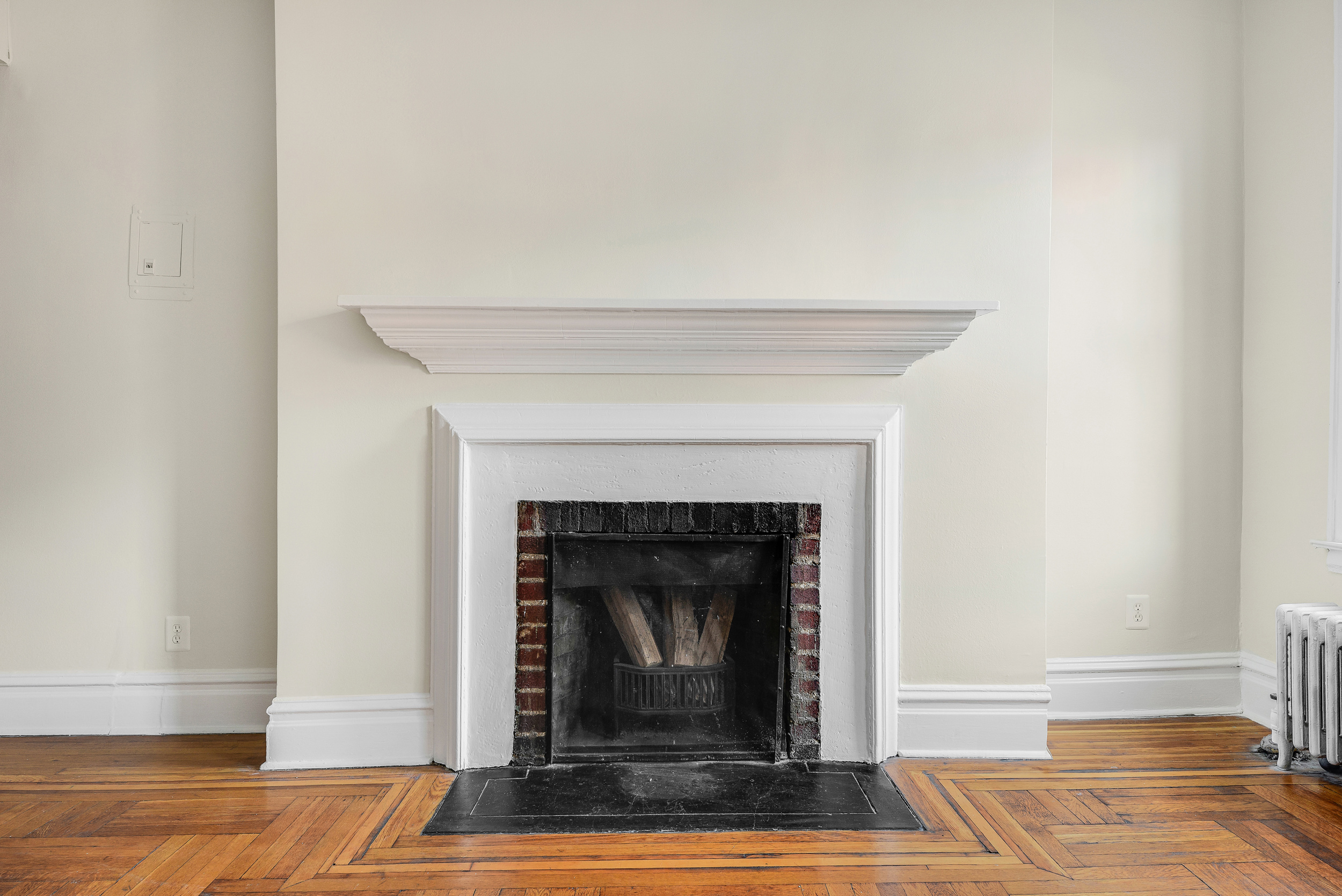 344 West 12th Street, Unit 5C Manhattan, NY 10014 - Photo 2 of 11 a living room with a fireplace and a rug