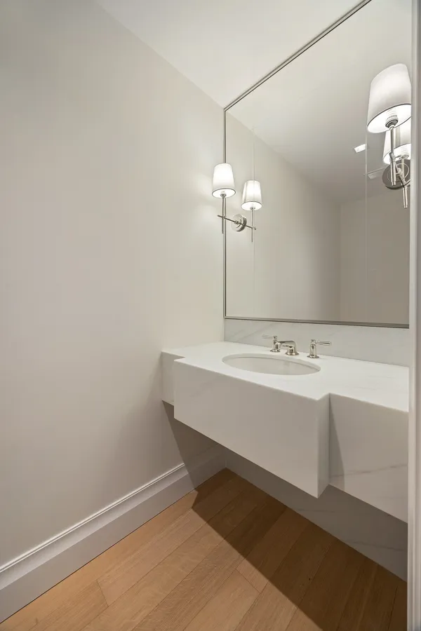 a view of a bathroom with a sink and mirror