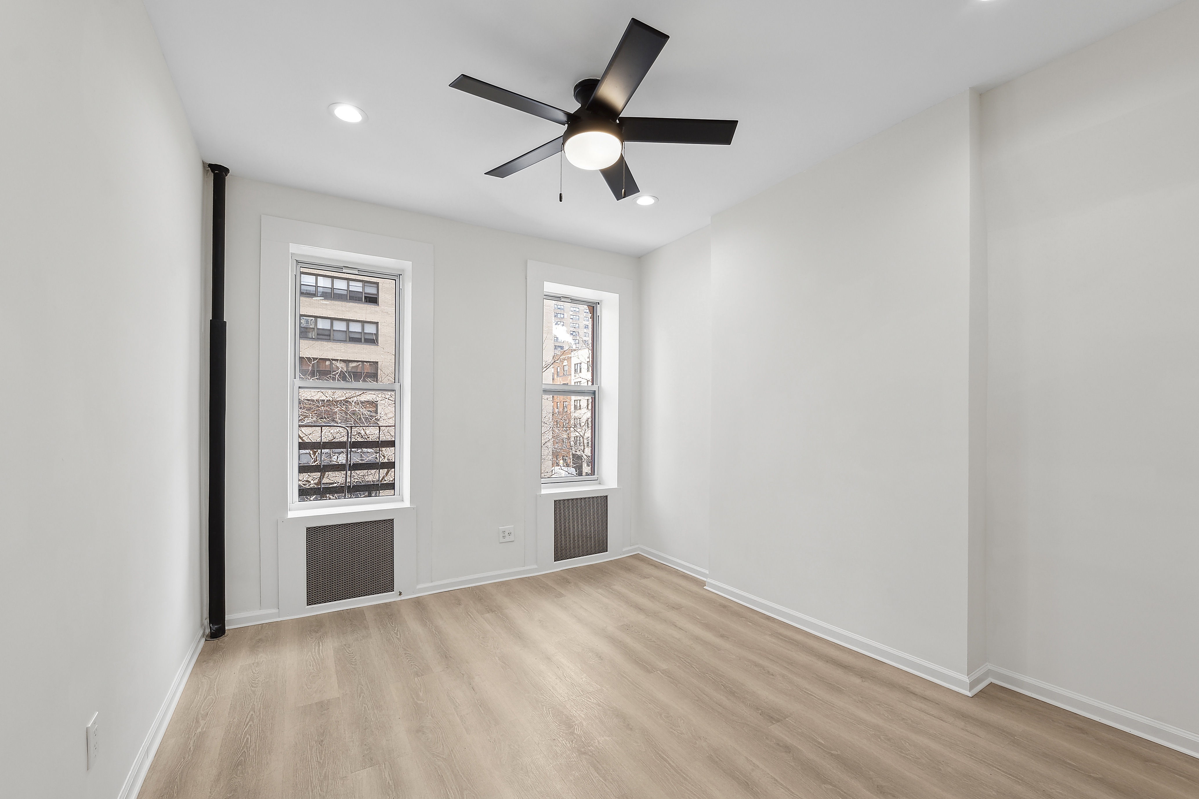398 3rd Avenue, Unit 2D Manhattan, NY 10016 - Photo 2 of 10 wooden floor in an empty room with a window