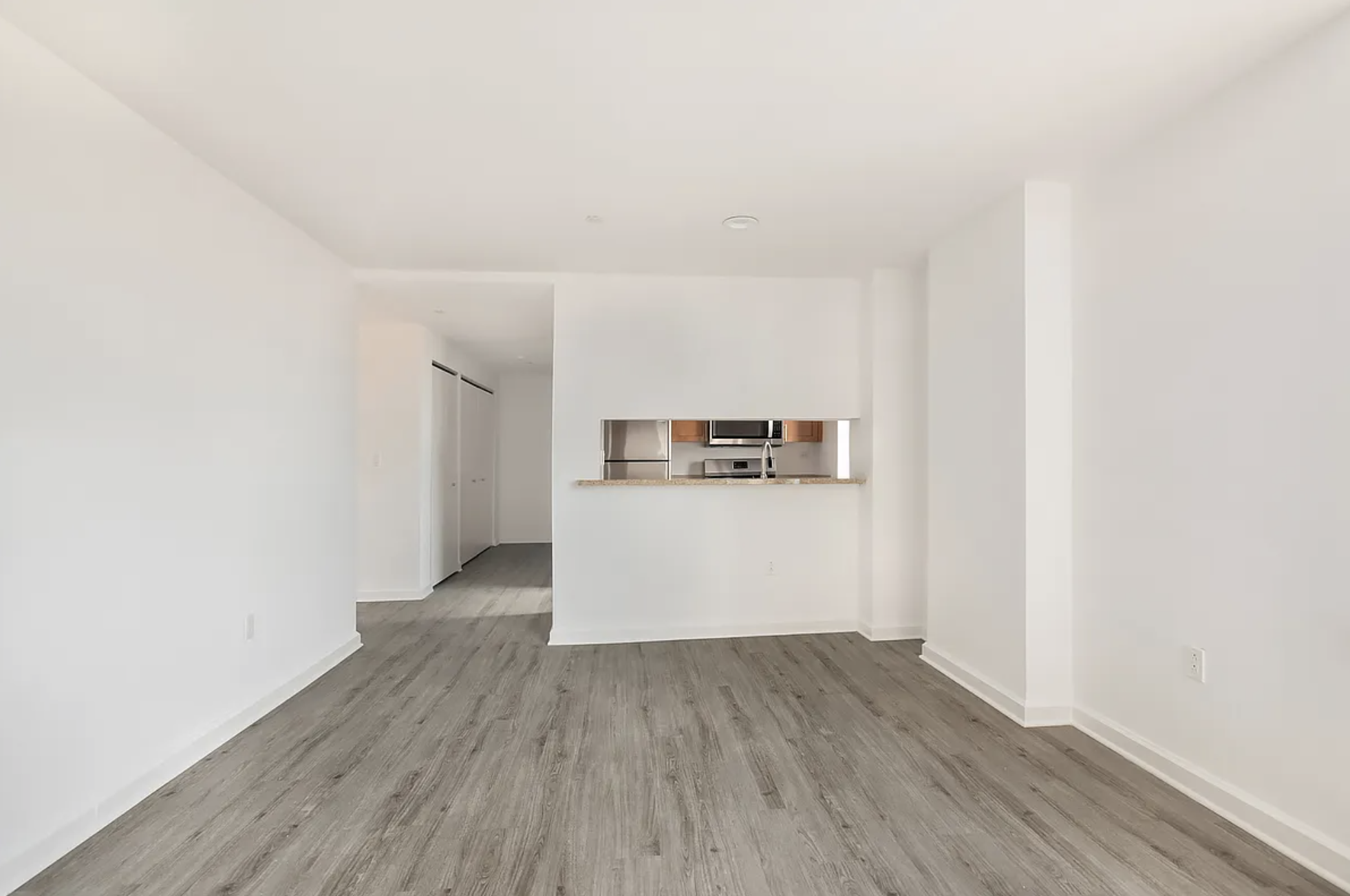 35 West 33rd Street, Unit 32C Manhattan, NY 10001 - Photo 2 of 21 a view of a kitchen with wooden floor and a sink