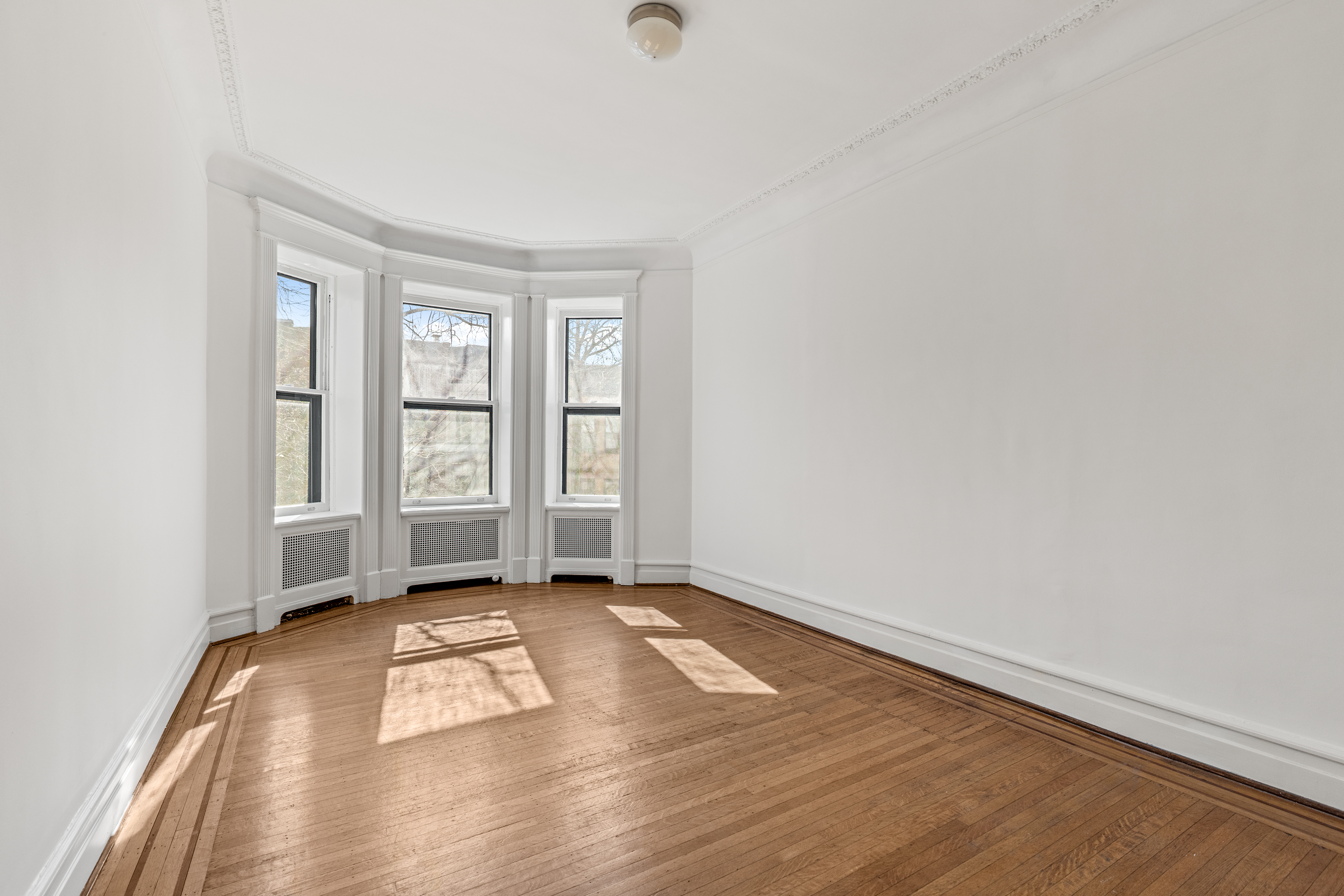 599 2nd Street Brooklyn, NY 11215 - Photo 11 of 16 an empty room with wooden floor and windows