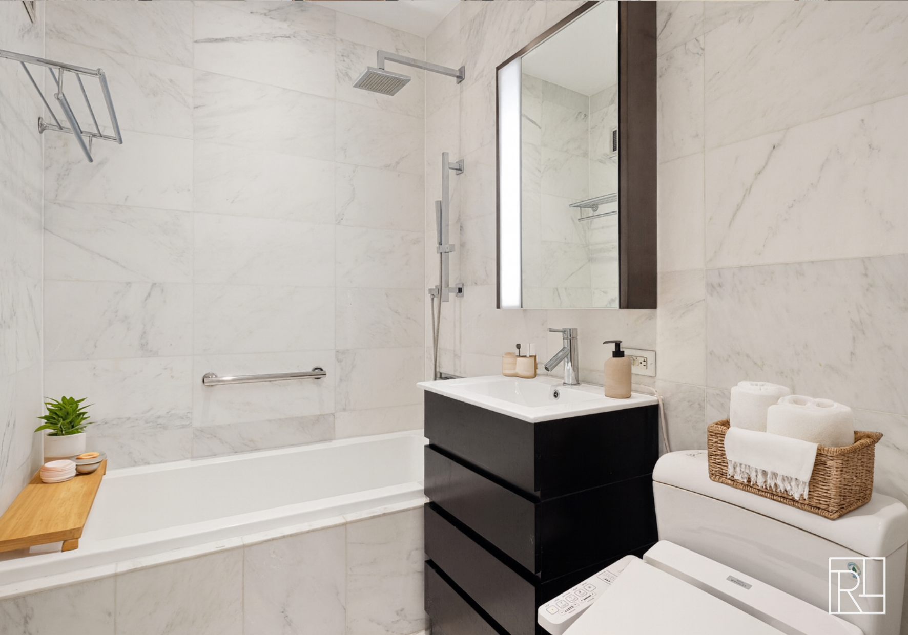 75 Wall Street, Unit 28D Manhattan, NY 10005 - Photo 9 of 35 a bathroom with a sink a toilet and shower