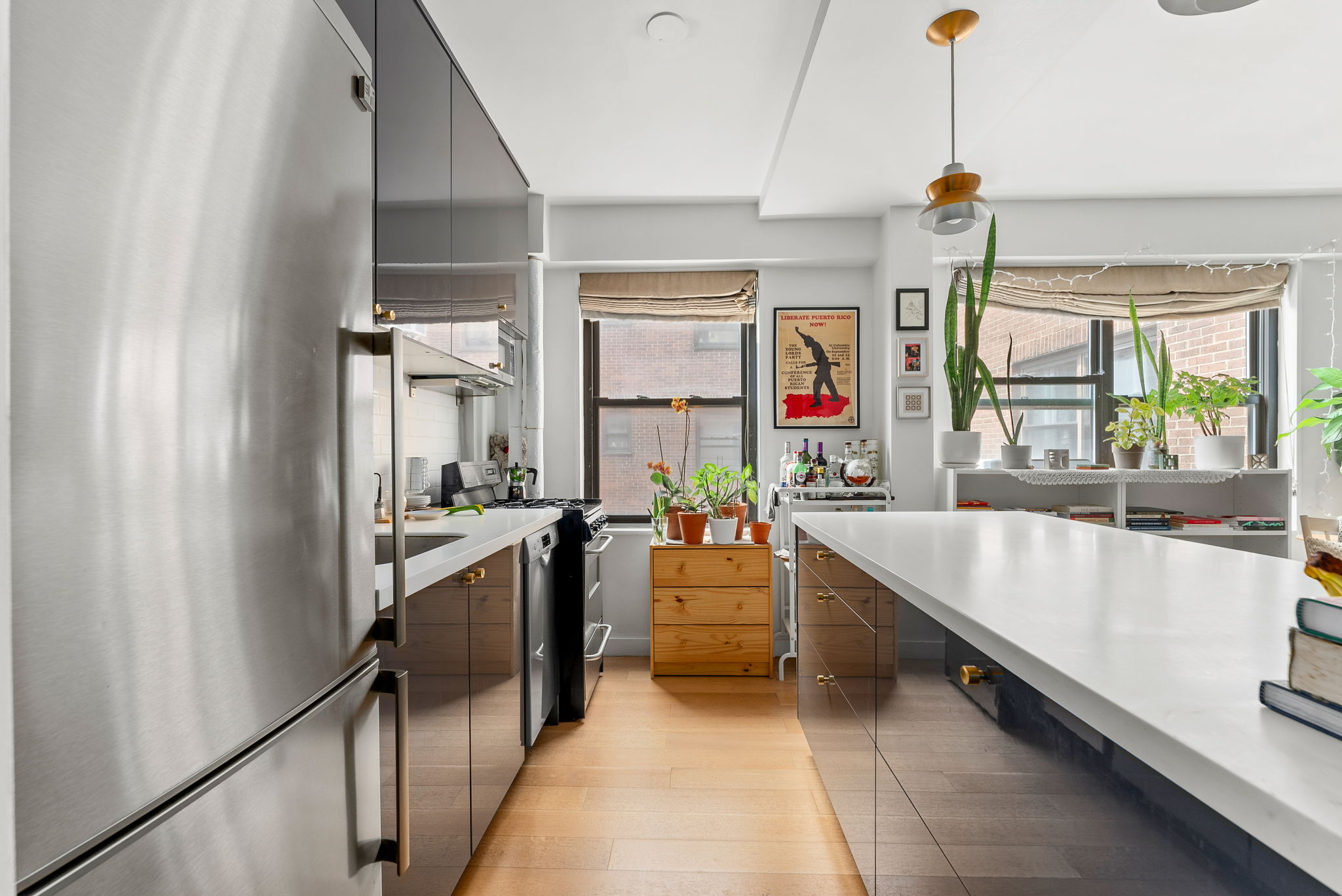 345 West 145th Street, Unit 11C2A Manhattan, NY 10031 - Photo 4 of 5 a large kitchen with kitchen island a large counter space appliances and windows