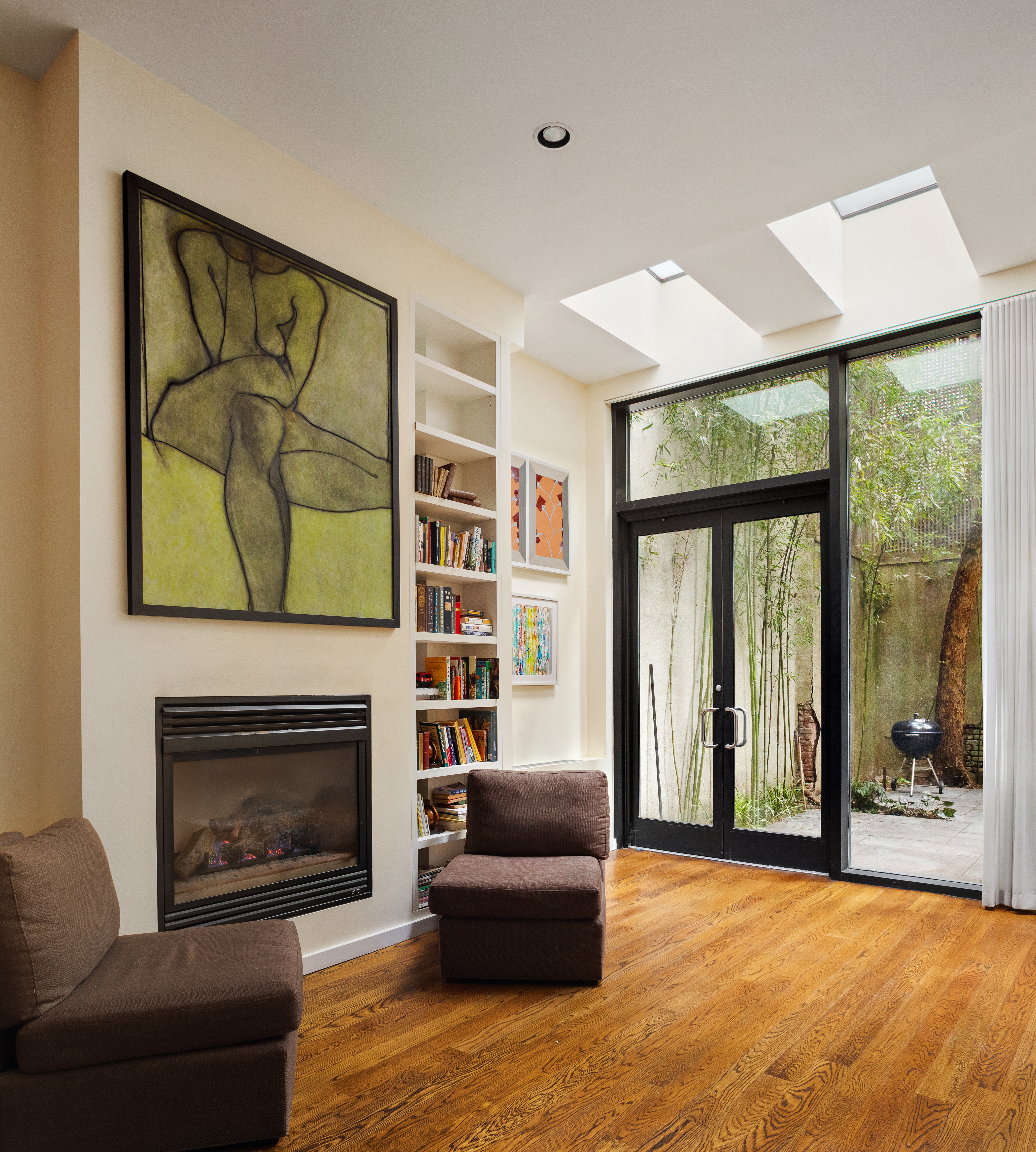 181 Sullivan Street, Unit GARDEN Manhattan, NY 10012 - Photo 4 of 10 a living room with furniture and a fireplace