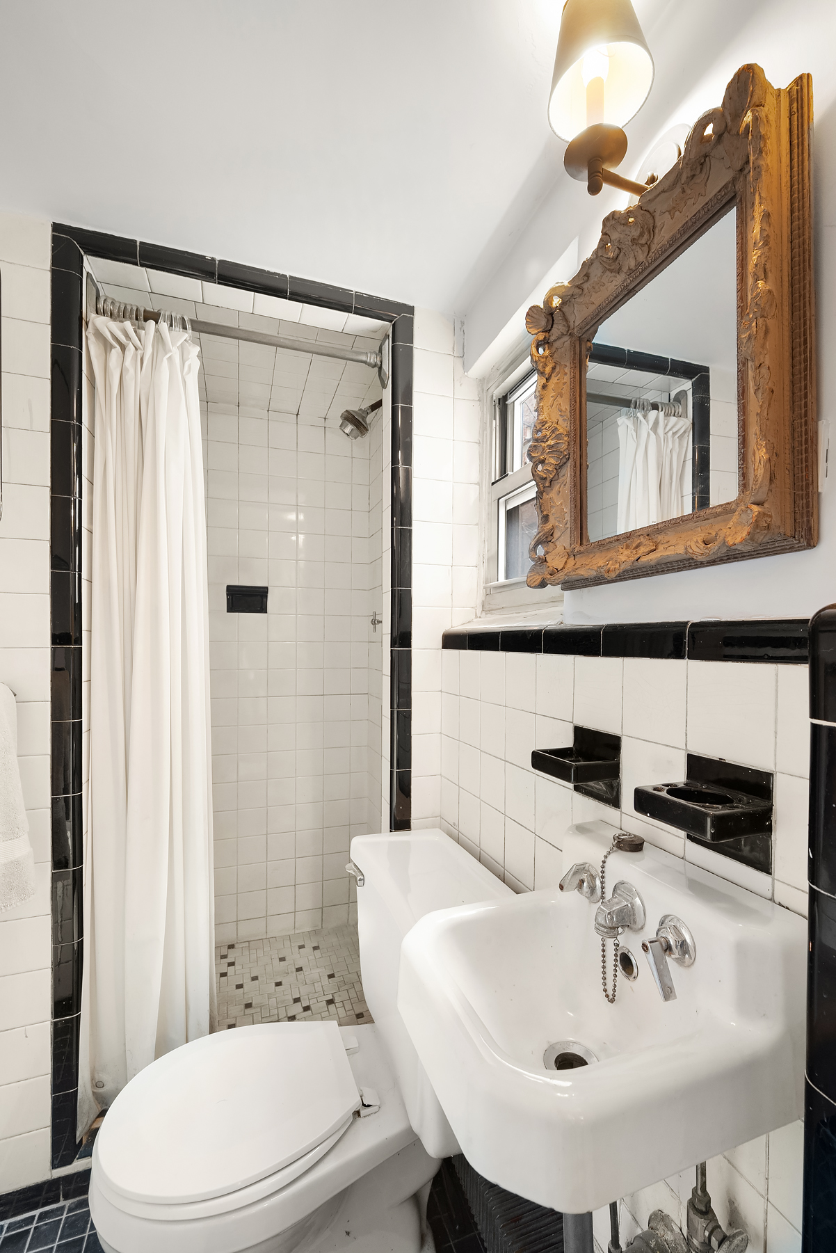 64 East 80th Street Manhattan, NY 10075 - Photo 12 of 14 a bathroom with a sink a toilet and shower curtain