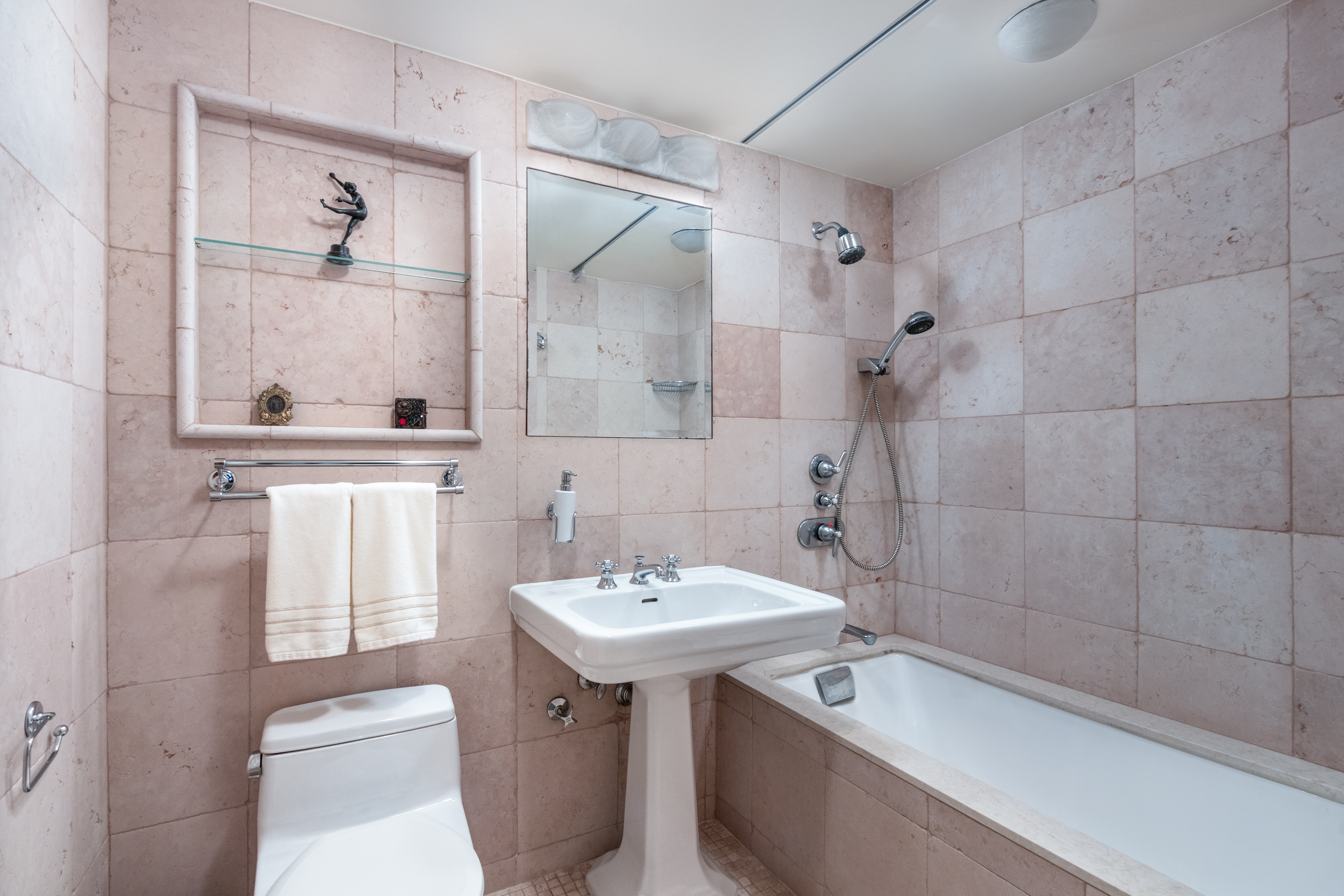 70 East 10th Street, Unit 14M Manhattan, NY 10003 - Photo 11 of 22 a bathroom with a sink a toilet and shower