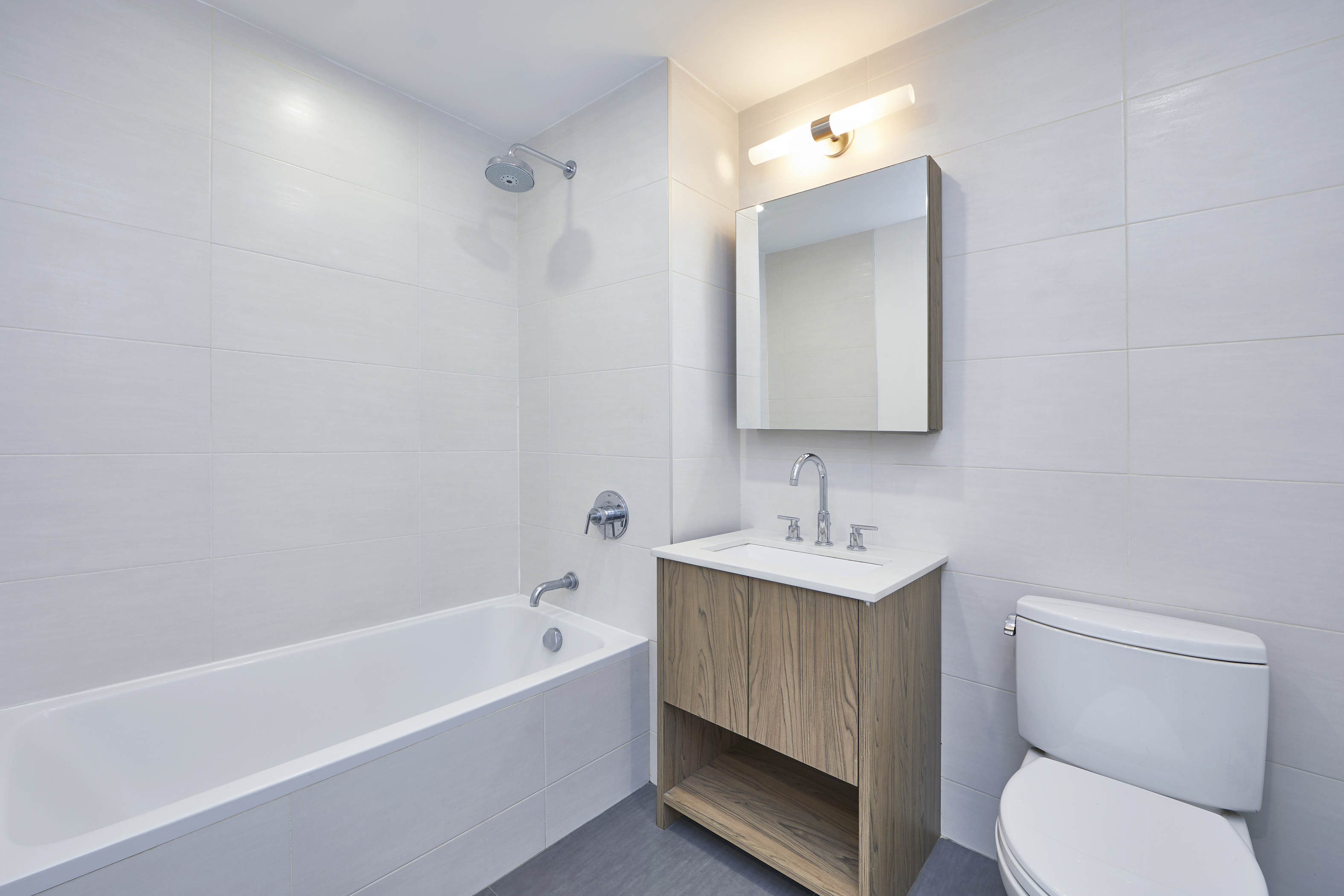 341 Eastern Parkway, Unit 8D Brooklyn, NY 11216 - Photo 6 of 7 a bathroom with a toilet a sink and a bathtub