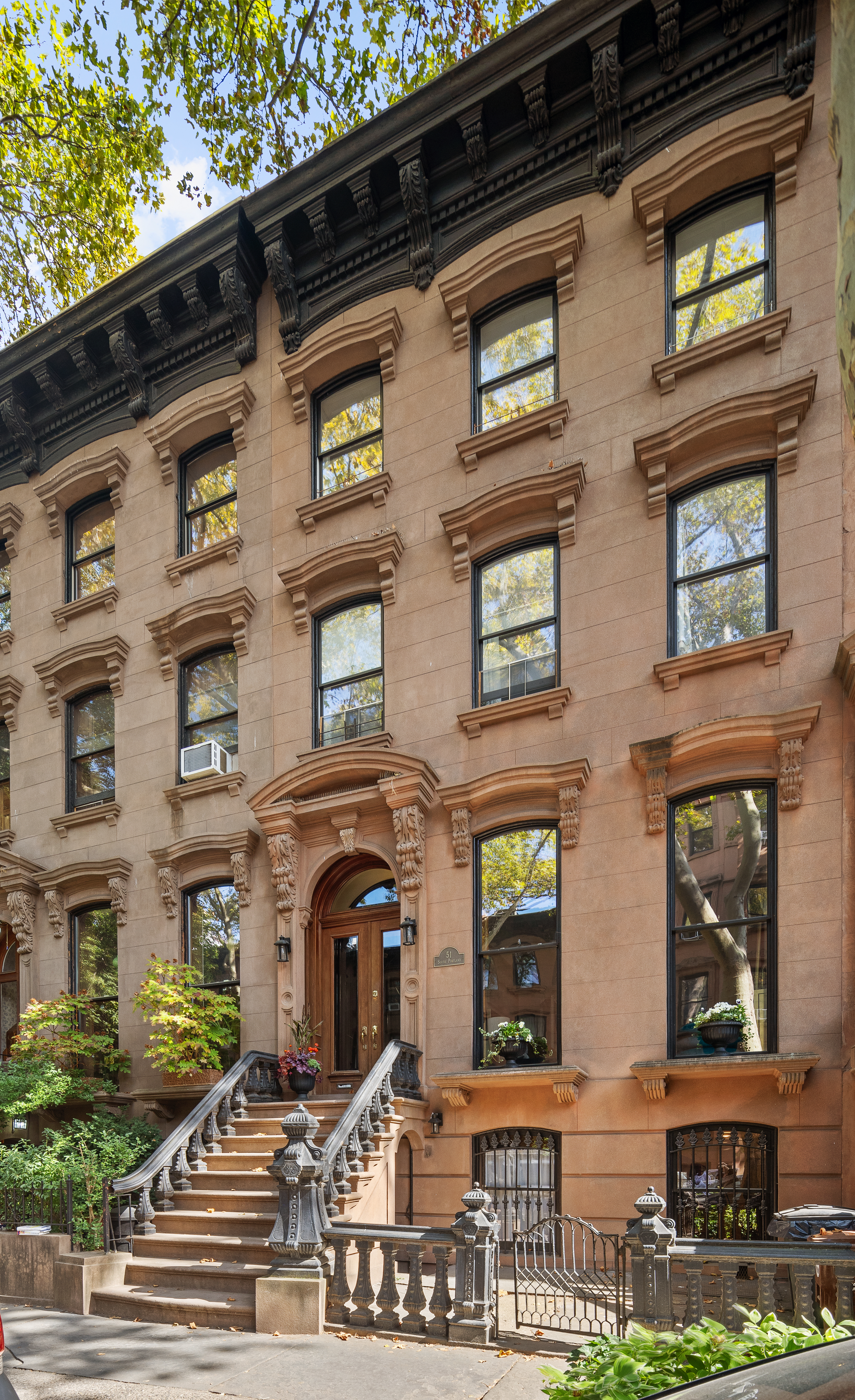 51 South Portland Avenue Brooklyn, NY 11217 - Photo 17 of 18 a front view of a residential apartment building with a yard