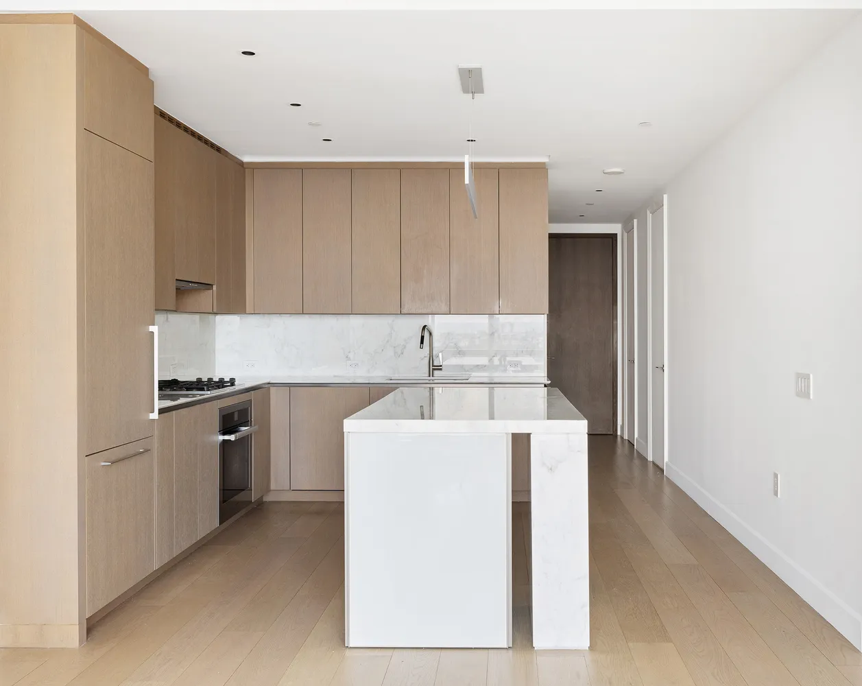 a kitchen with a sink a stove and cabinets