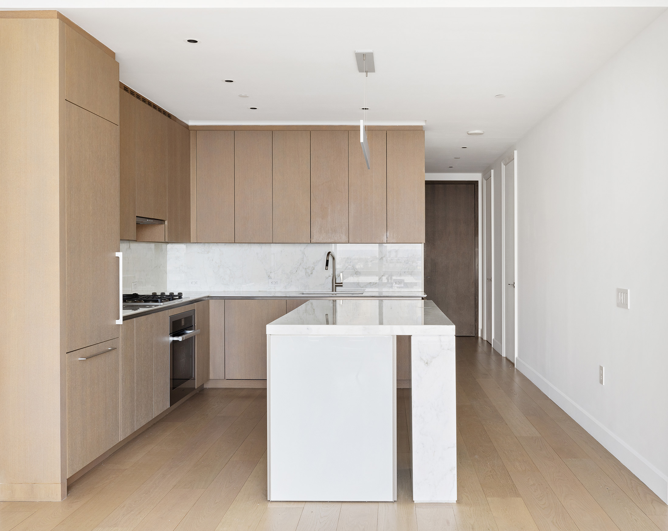 15 Hudson Yards, Unit 29E Manhattan, NY 10001 - Photo 3 of 6 a kitchen with a sink a stove and cabinets