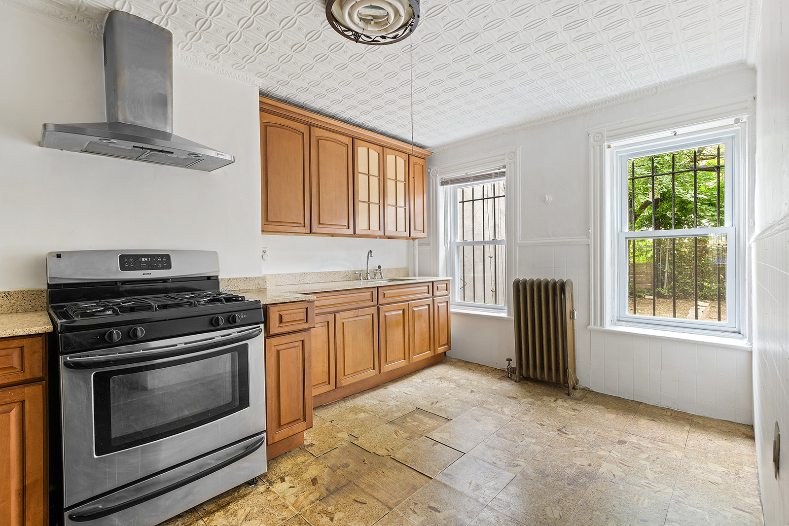 1599 A Pacific Street Brooklyn, NY 11213 - Photo 10 of 14 a kitchen with stainless steel appliances granite countertop a stove a sink and a refrigerator