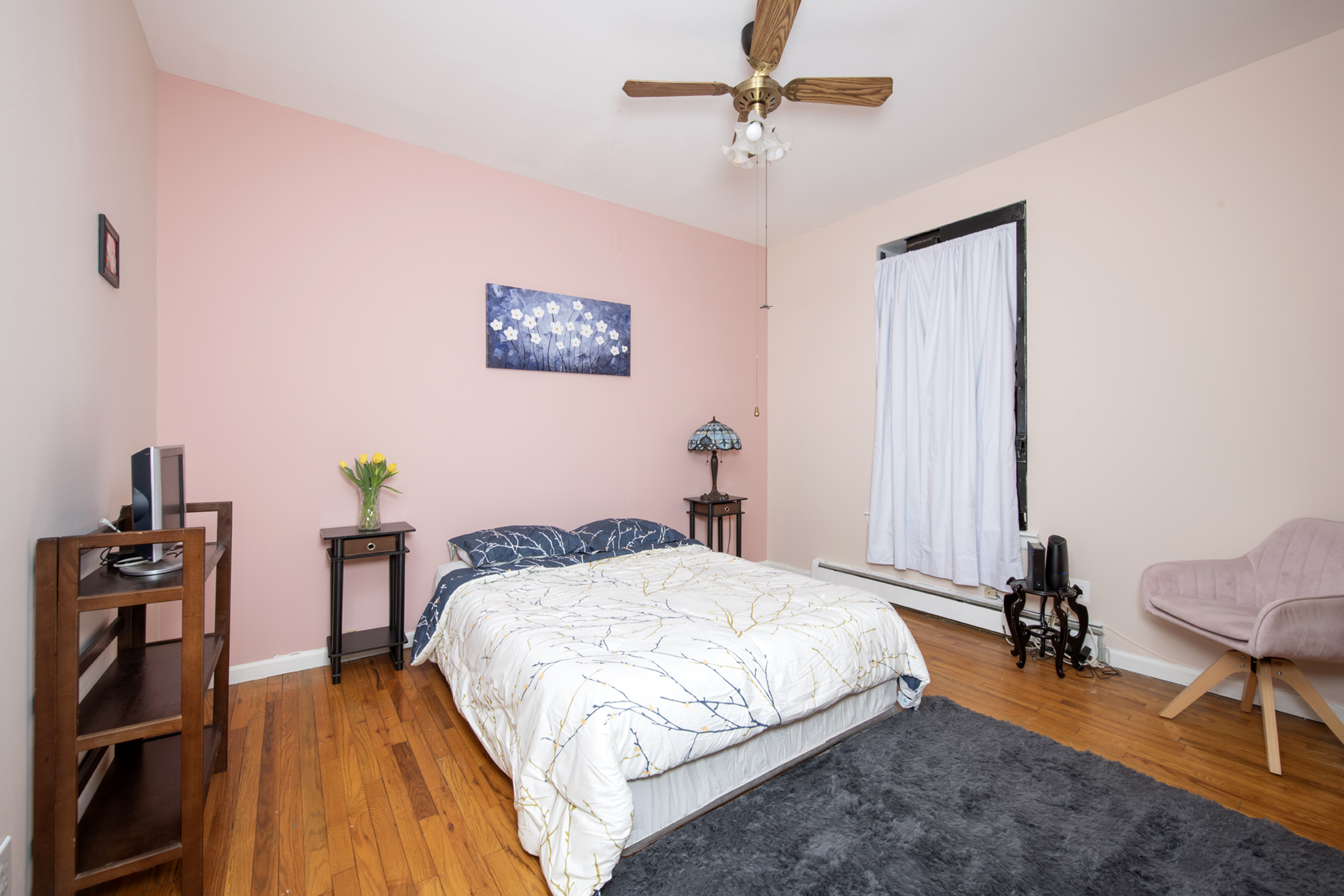 352 West 117th Street, Unit 1E Manhattan, NY 10026 - Photo 8 of 13 a bed room with a bed and a chair
