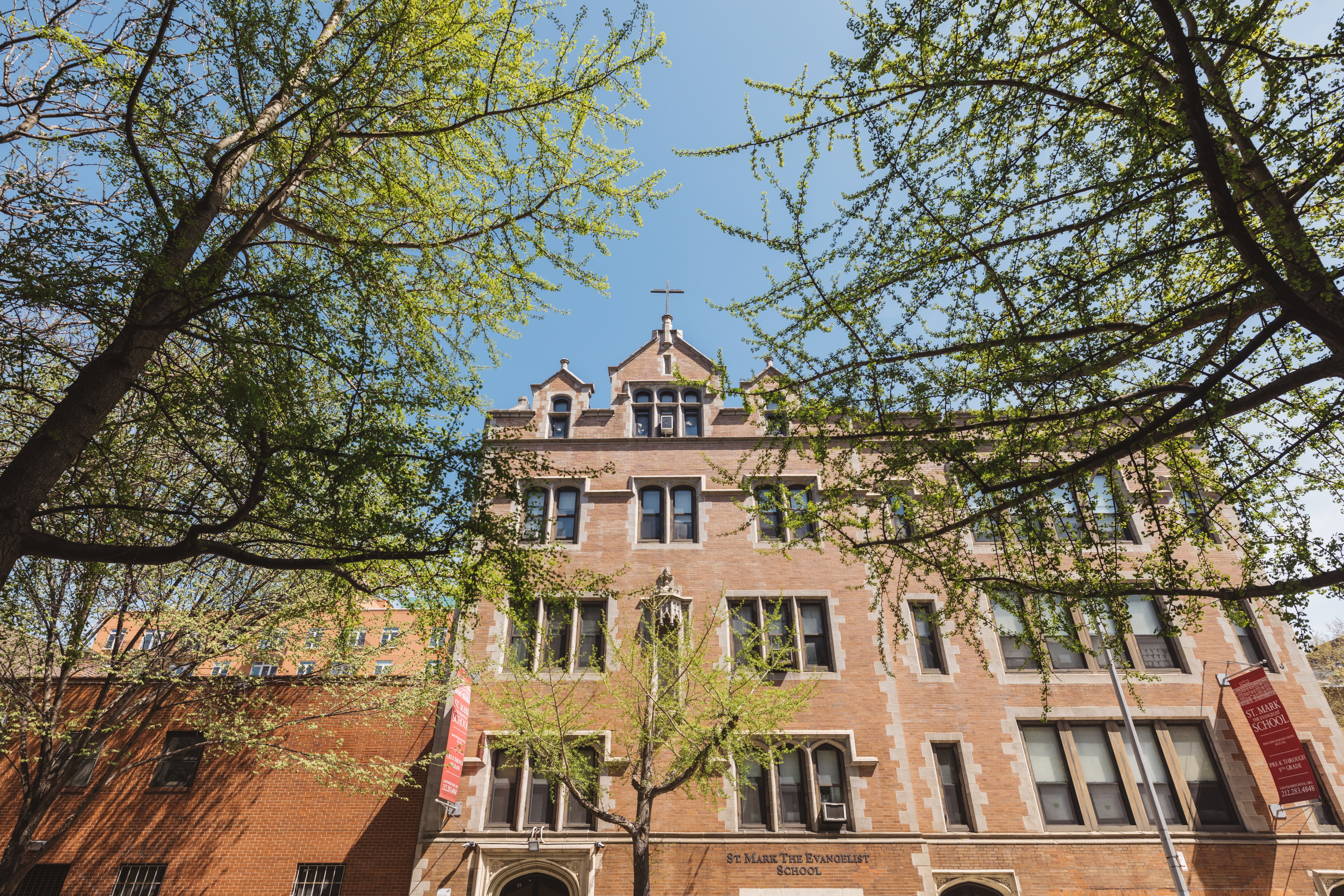 48 West 138th Street, Unit 5J Manhattan, NY 10037 - Photo 8 of 13 a front view of a house with a tree