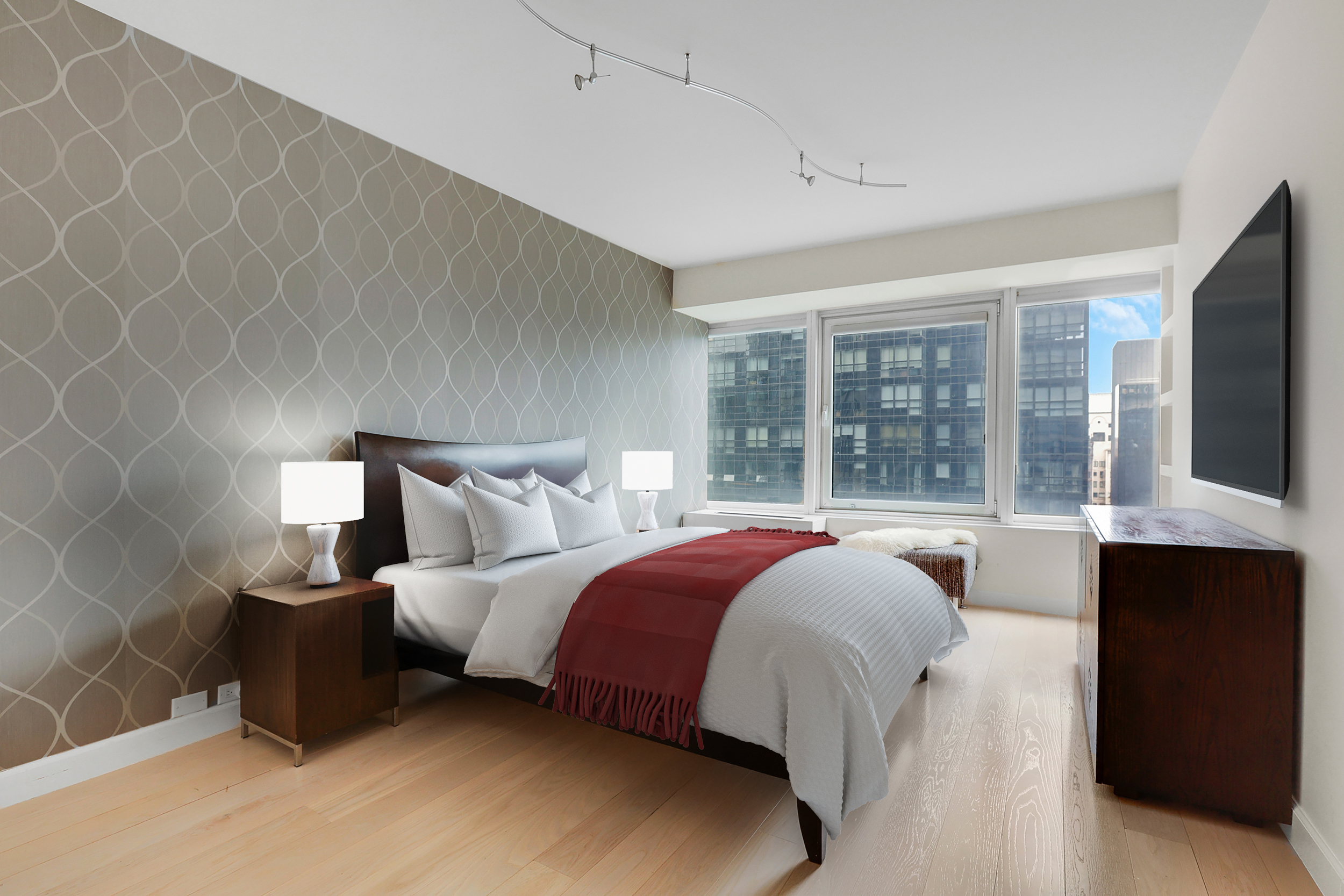 150 West 56th Street, Unit 3602 Manhattan, NY 10019 - Photo 4 of 12 a bed sitting in a bedroom next to a window