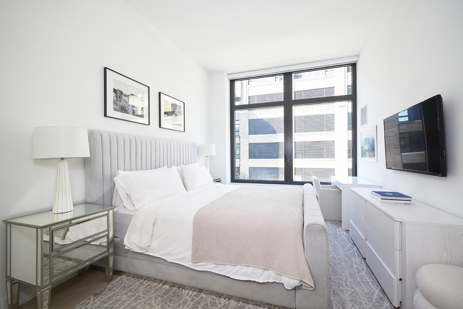 77 Charlton Street, Unit N10C Manhattan, NY 10014 - Photo 4 of 24 a bedroom with a bed and a flat screen tv