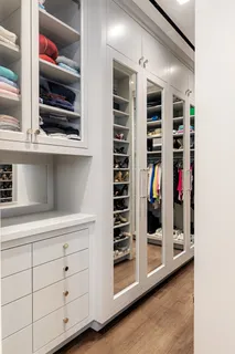 a bedroom with furniture and a large window