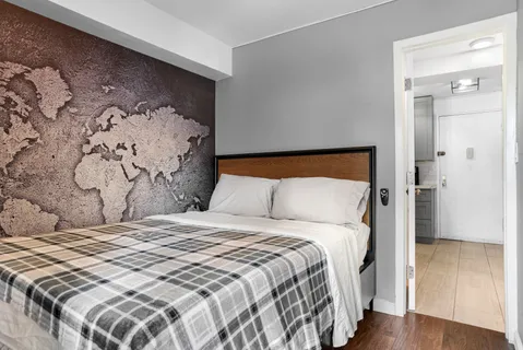 a large bed in a bedroom next to a small yard