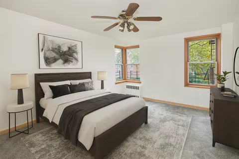 a spacious bedroom with a bed and a chandelier