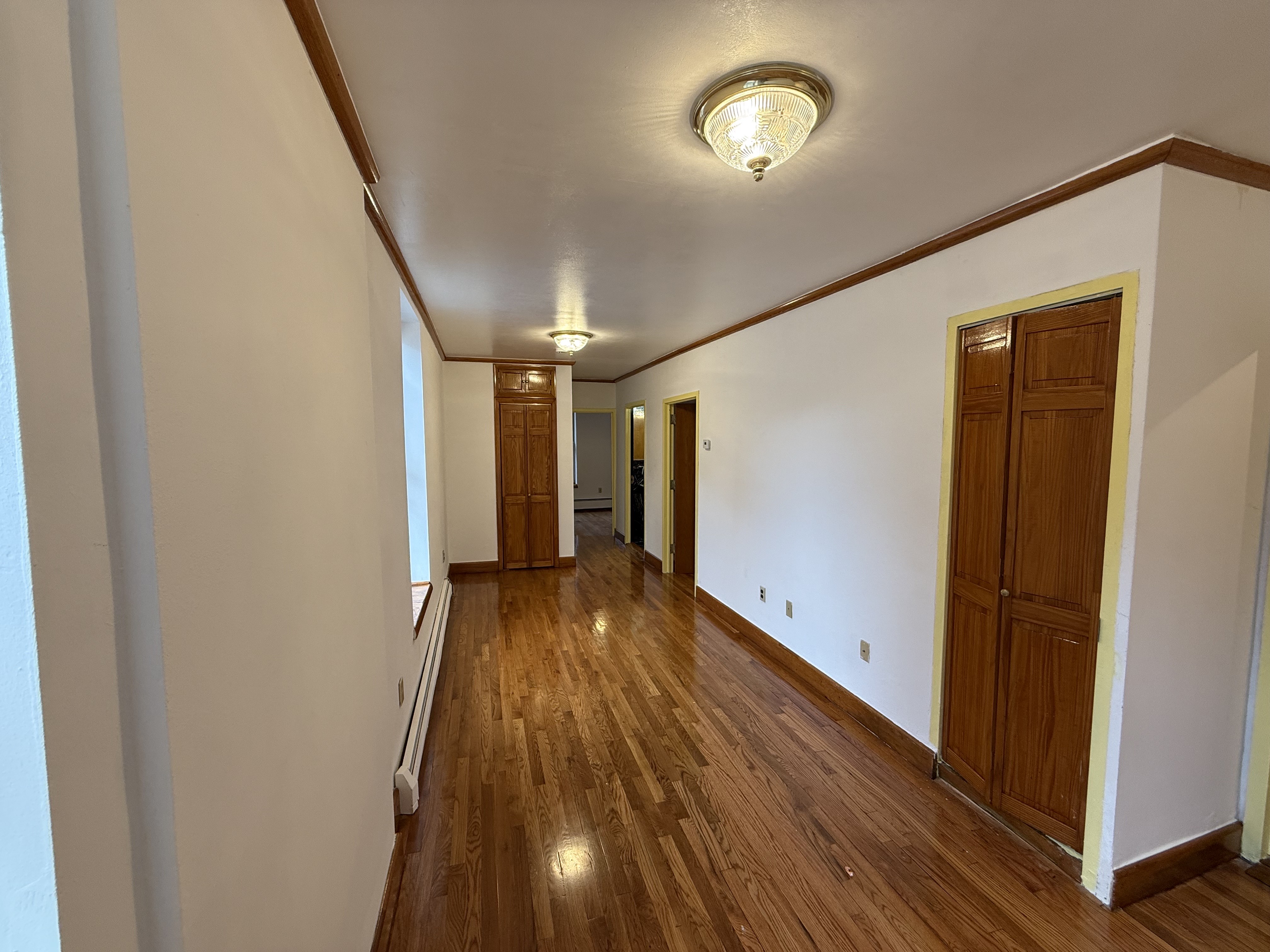 423 Lincoln Place, Unit 2 Brooklyn, NY 11238 - Photo 5 of 6 a view of a hallway with wooden floor