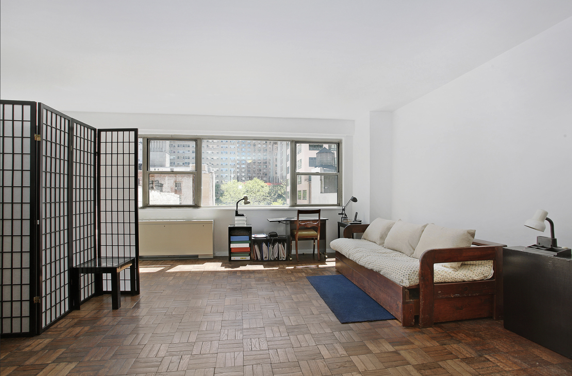321 East 48th Street, Unit 7F Manhattan, NY 10017 - Photo 4 of 7 a living room with furniture and a window