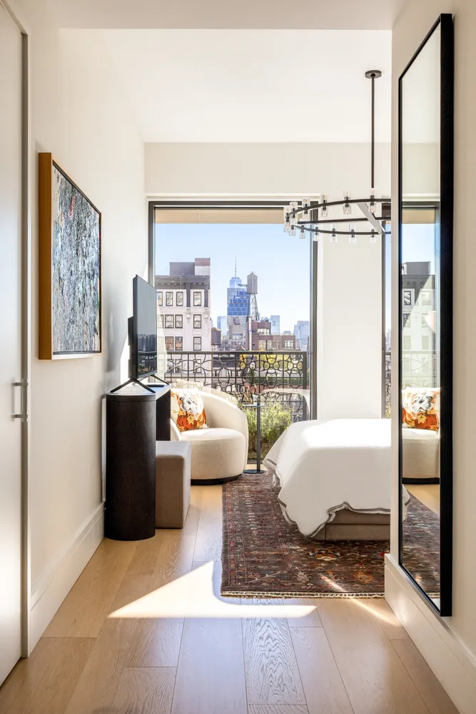 a living room with furniture and a floor to ceiling window