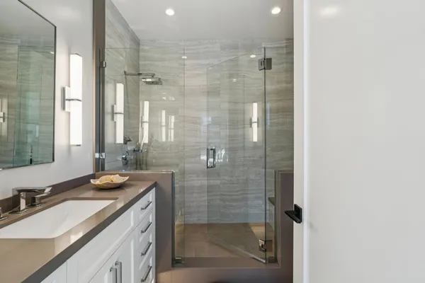 a kitchen with stainless steel appliances white cabinets and wooden floors