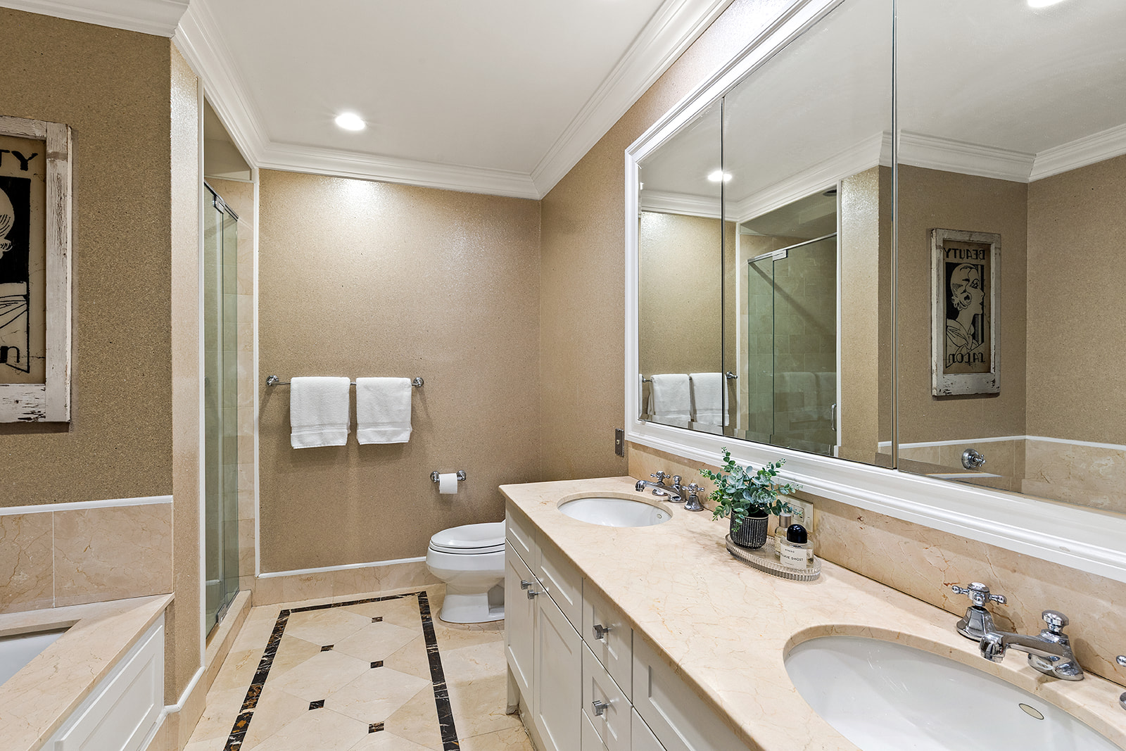 90 East End Avenue, Unit 4B Manhattan, NY 10028 - Photo 5 of 13 a bathroom with a double vanity sink and mirror with toilet