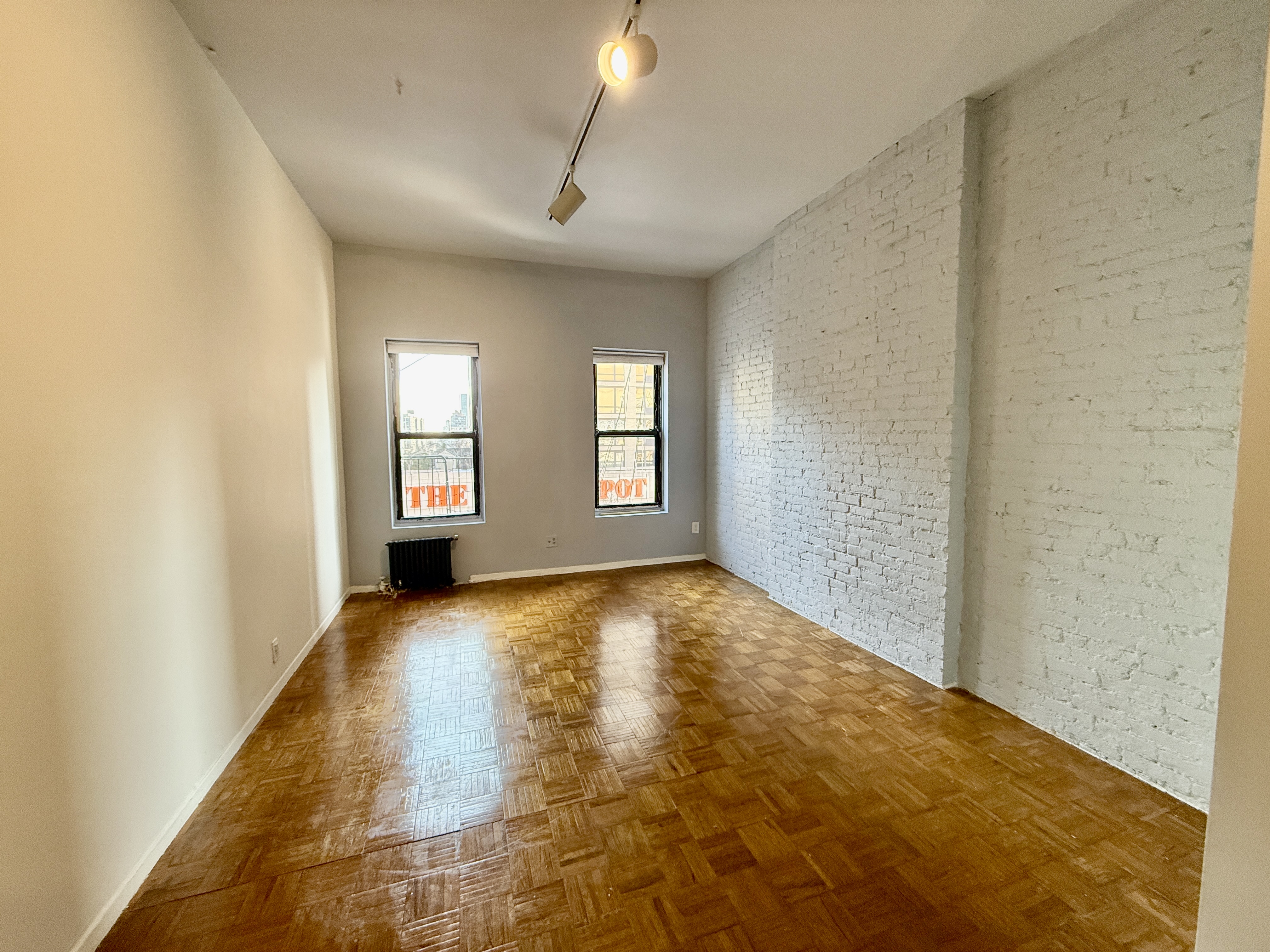 344 East 61st Street, Unit 16 Manhattan, NY 10065 - Photo 6 of 8 a view of an empty room and window