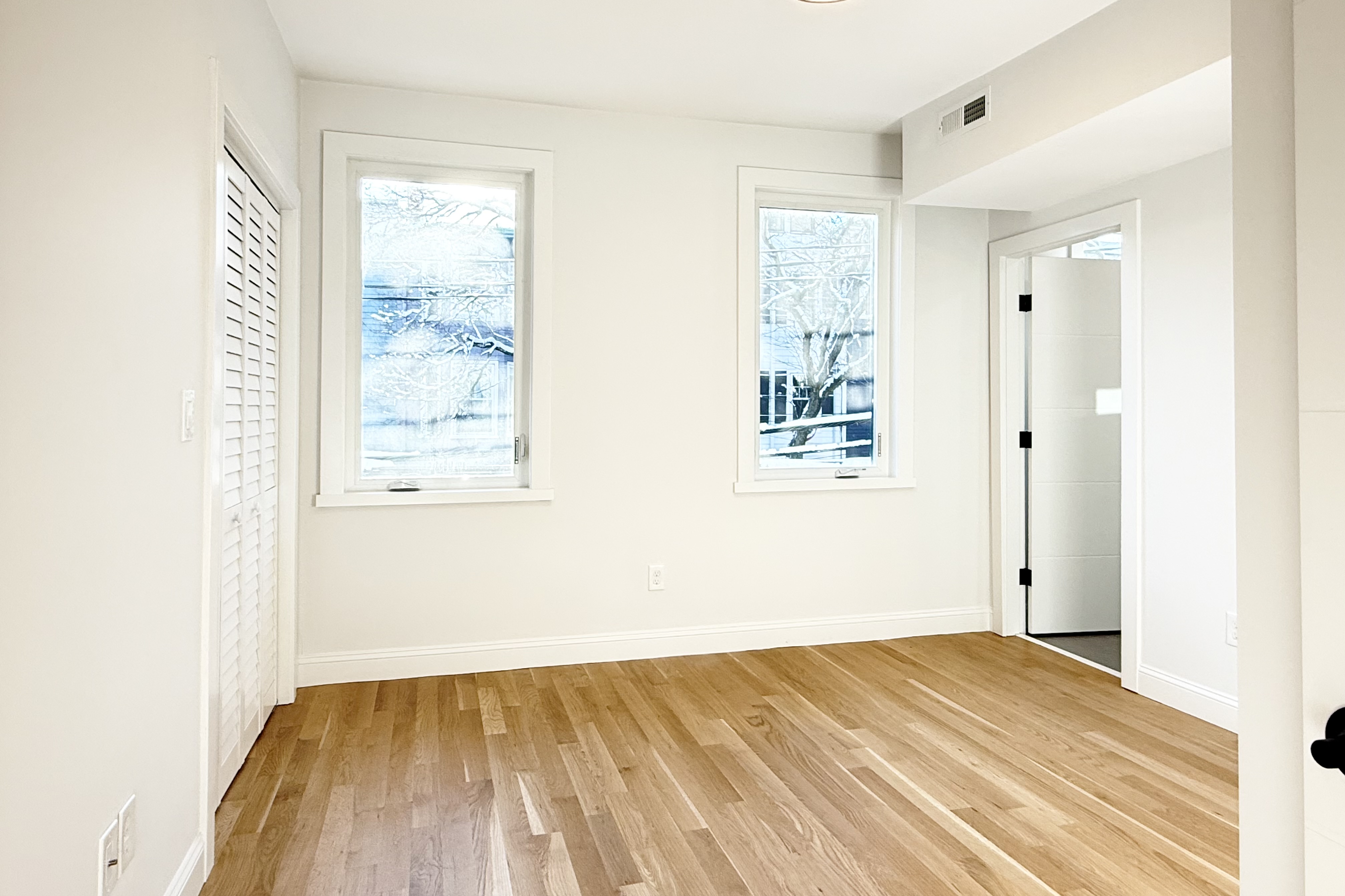 76 Webster Street East Boston, MA 02128 - Photo 4 of 8 a view of empty room with wooden floor and fan
