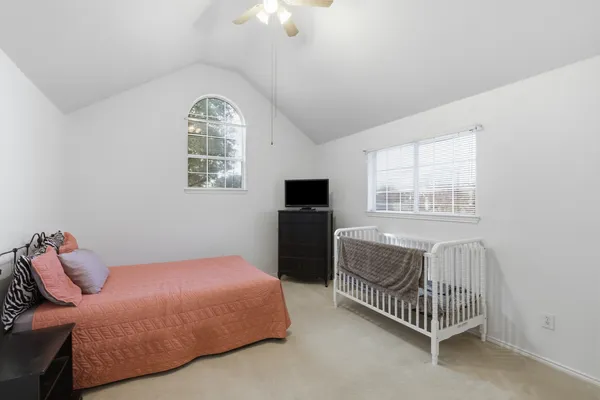 a bedroom with a bed and a tv