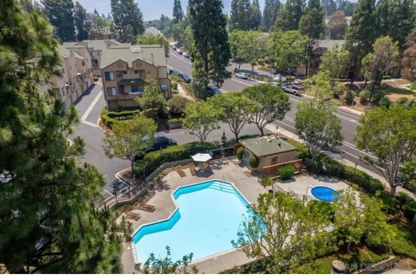 an aerial view of a house with a yard and lake view