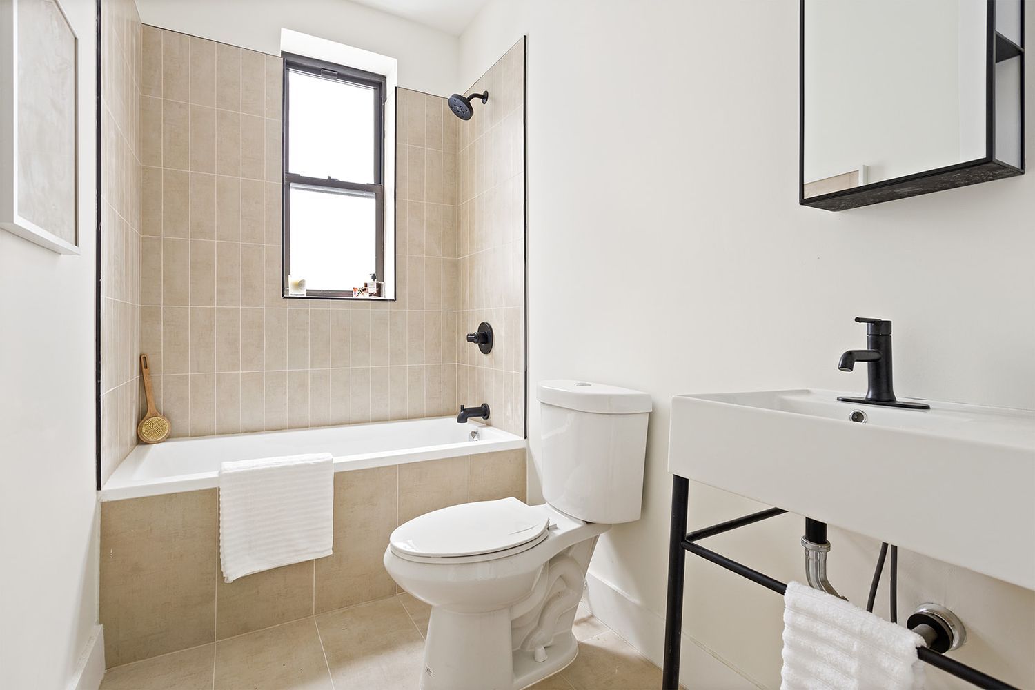 917 Saint Marks Avenue, Unit 3 Brooklyn, NY 11213 - Photo 9 of 12 a bathroom with a toilet a sink a mirror and bathtub