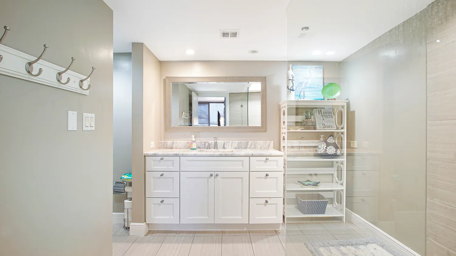 a bathroom with a sink vanity and mirror