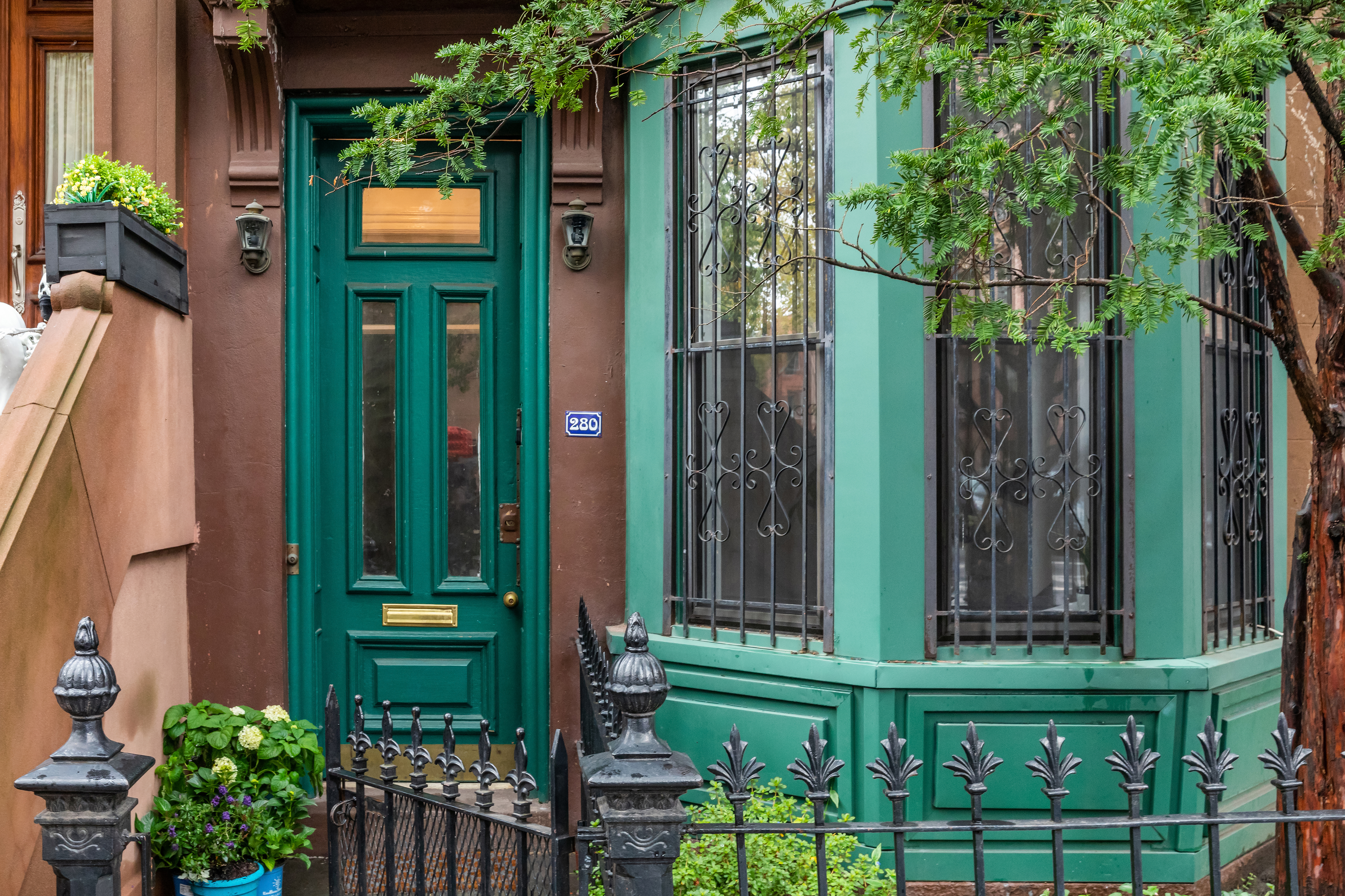 a view of a house with a small yard and potted plants