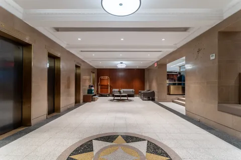 a view of a livingroom with kitchen and furniture