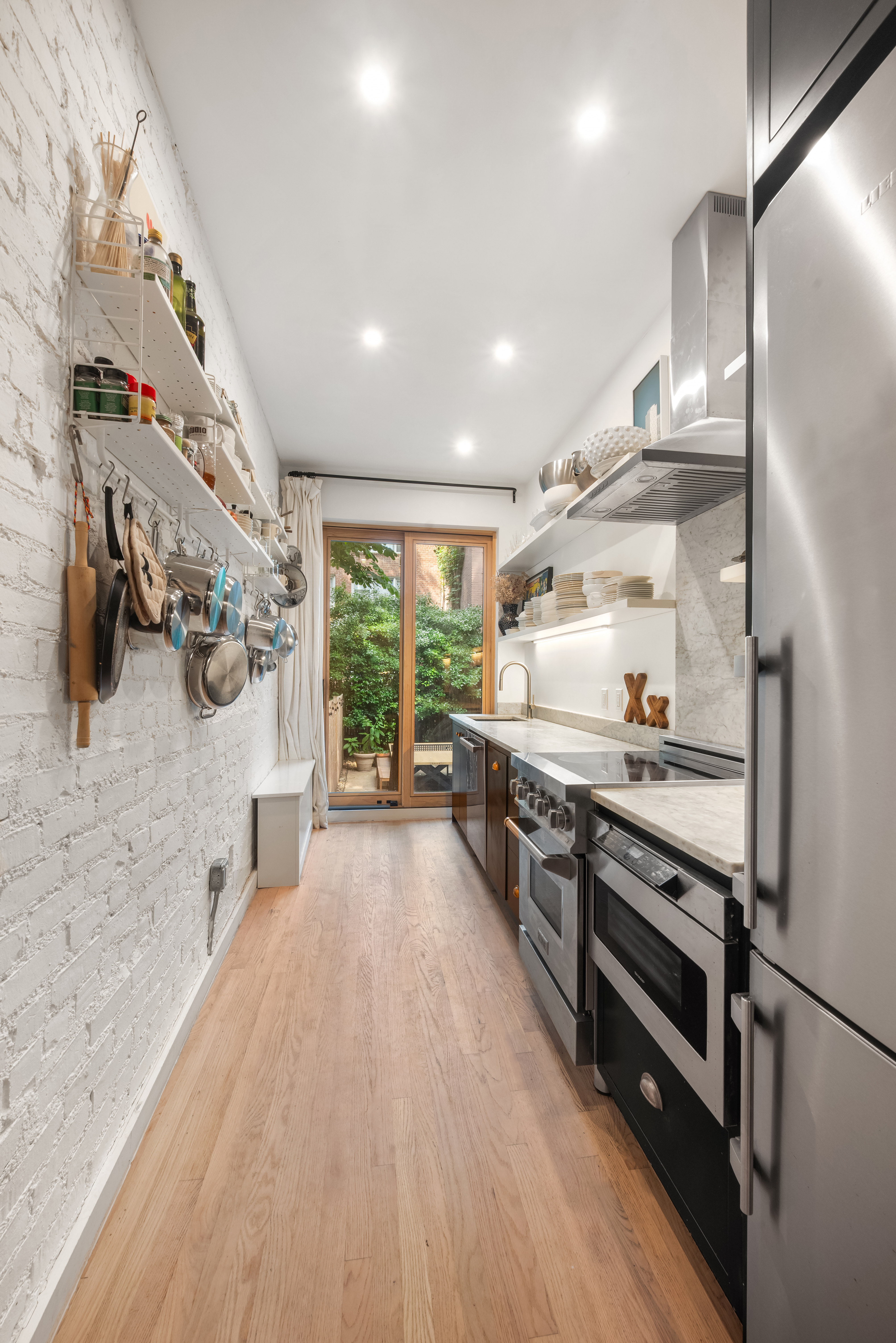 151 East 29th Street, Unit 1 Manhattan, NY 10016 - Photo 5 of 14 a large kitchen with stainless steel appliances