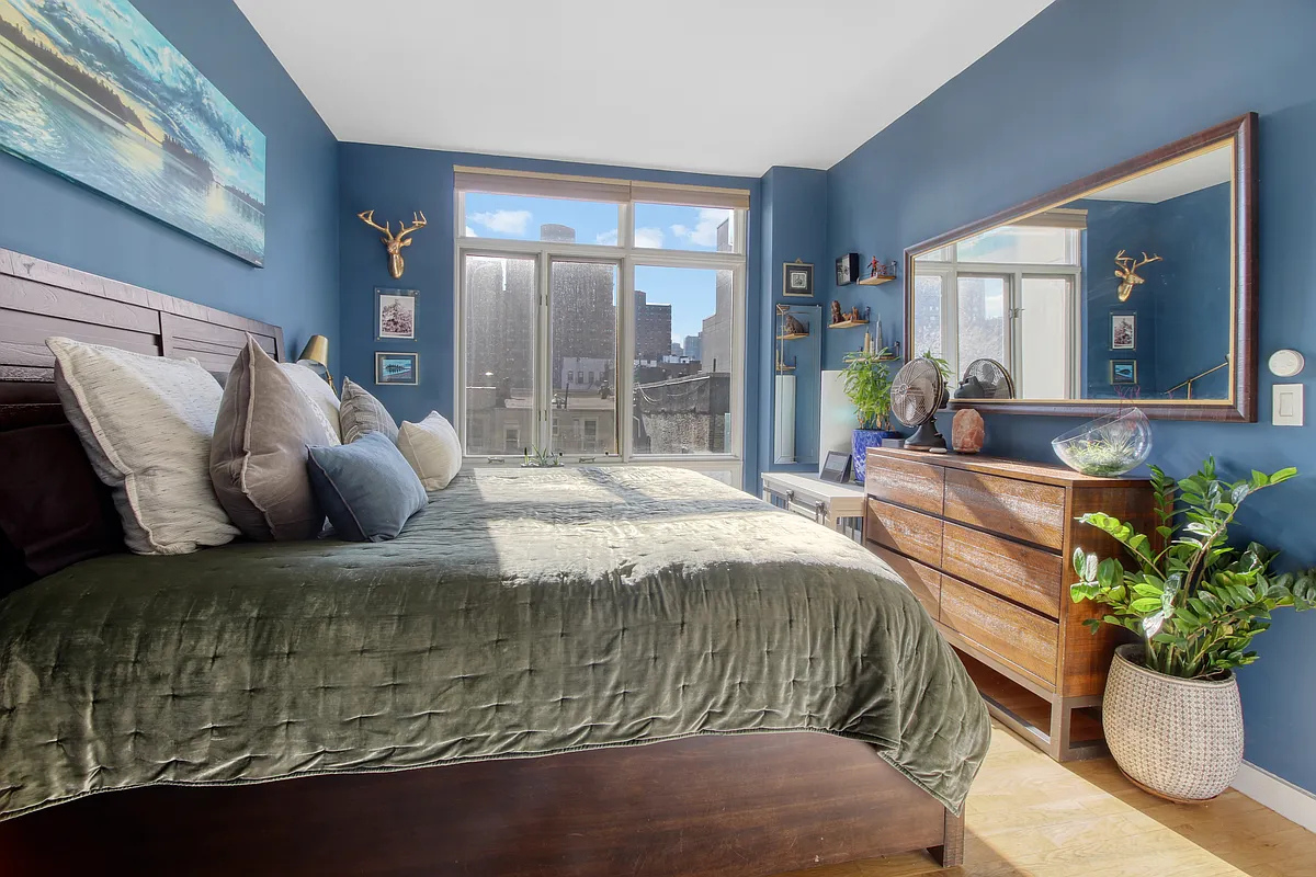 342 East 110th Street, Unit 5E Manhattan, NY 10029 - Photo 10 of 23 a large bed sitting in a bedroom next to a window